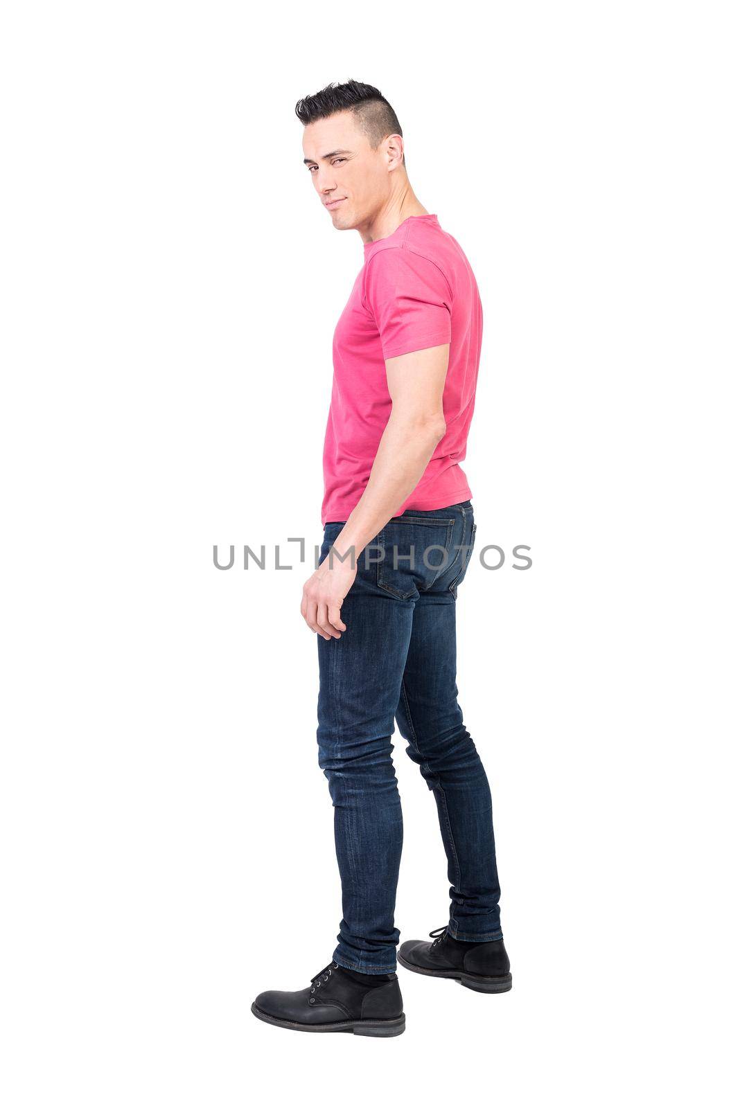 Full body side view of masculine male model winking at camera against white background