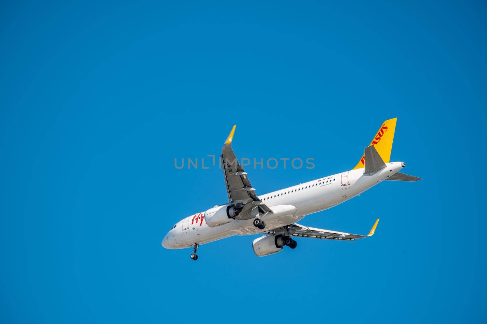 Commercial airplane flying high in clear blue sky
