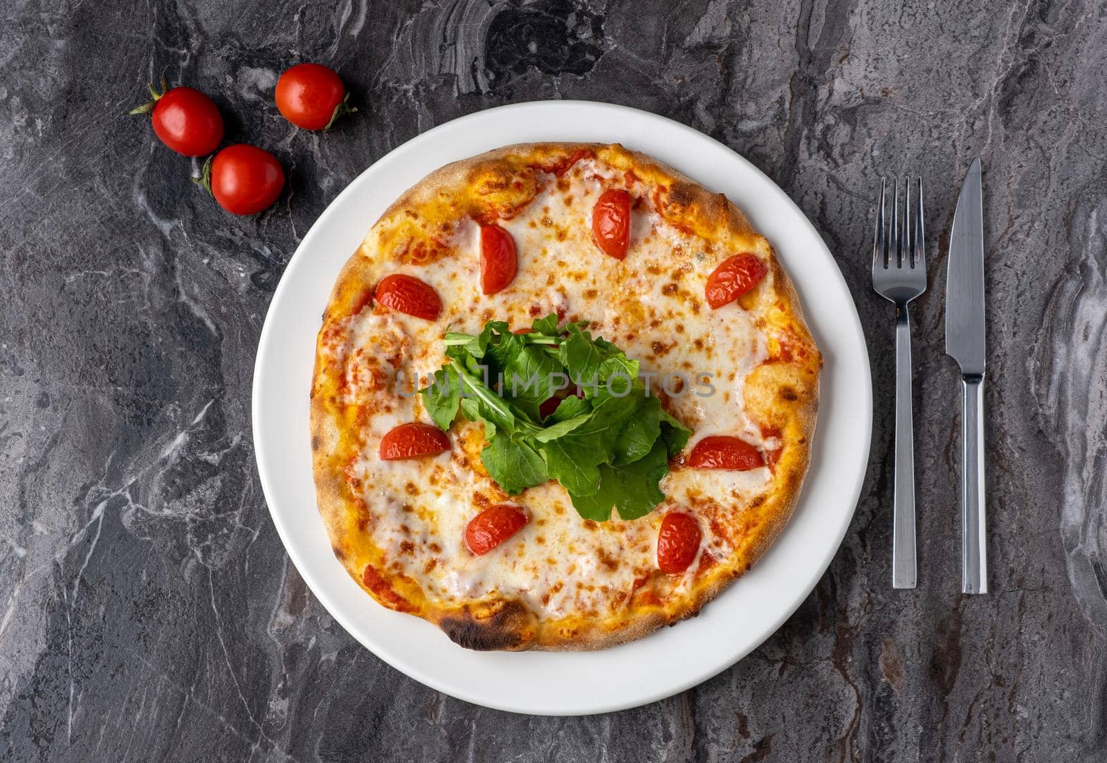 Delicious hot homemade pizza on the stone table background