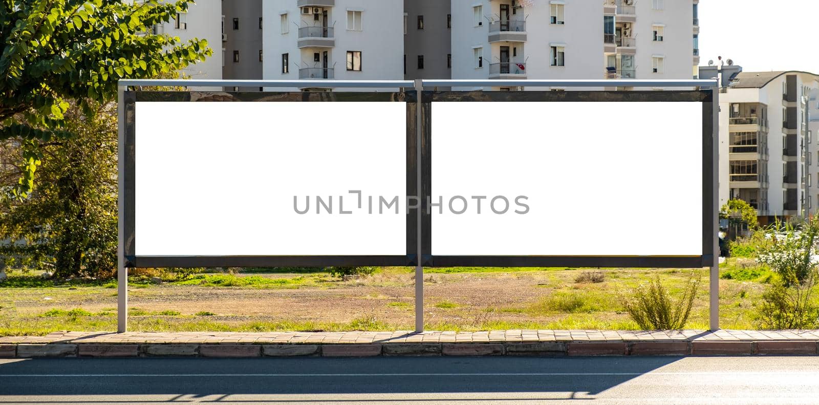 blank open air billboard megaboard mock up in the city on sunny day