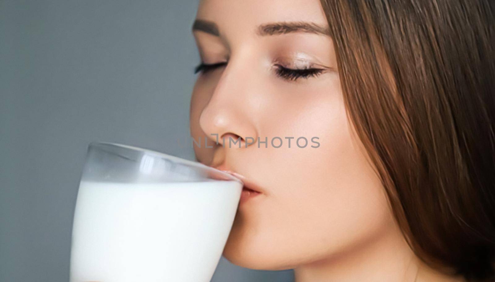 Diet and wellness, young woman drinking milk or protein shake cocktail, portrait