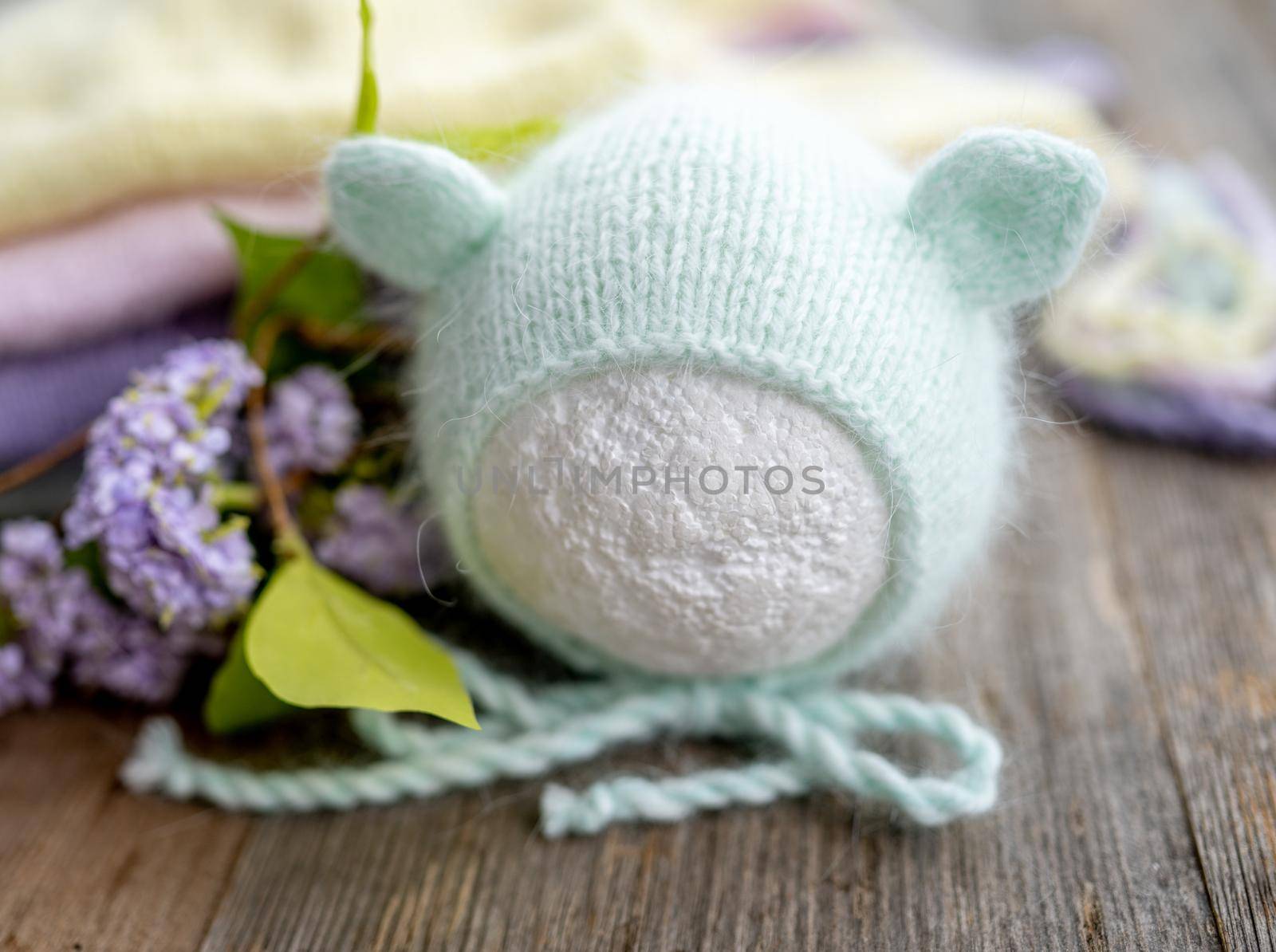 tender knitted for newborn on wooden background