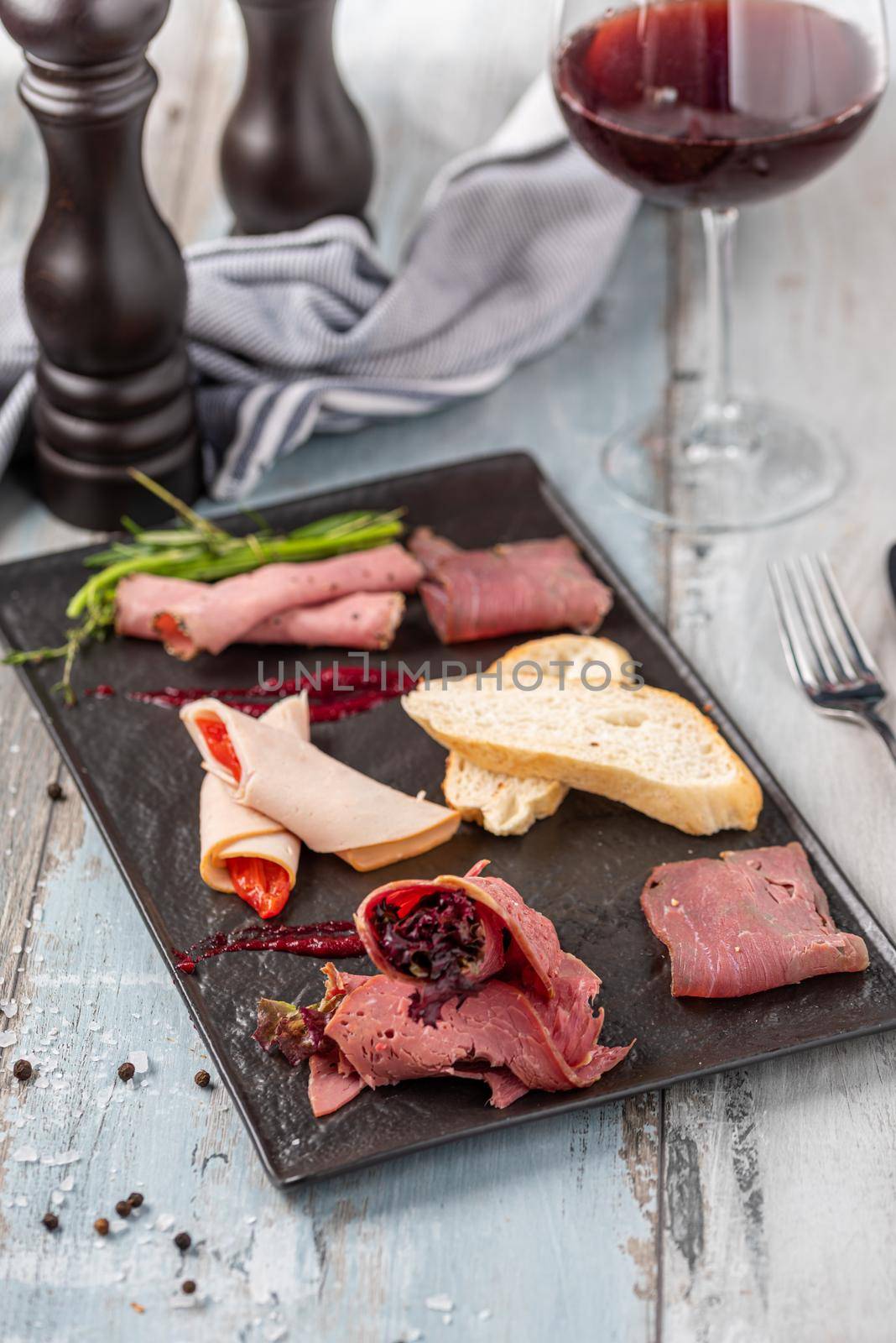 Appetizers table with italian antipasti snacks and wine in glasses