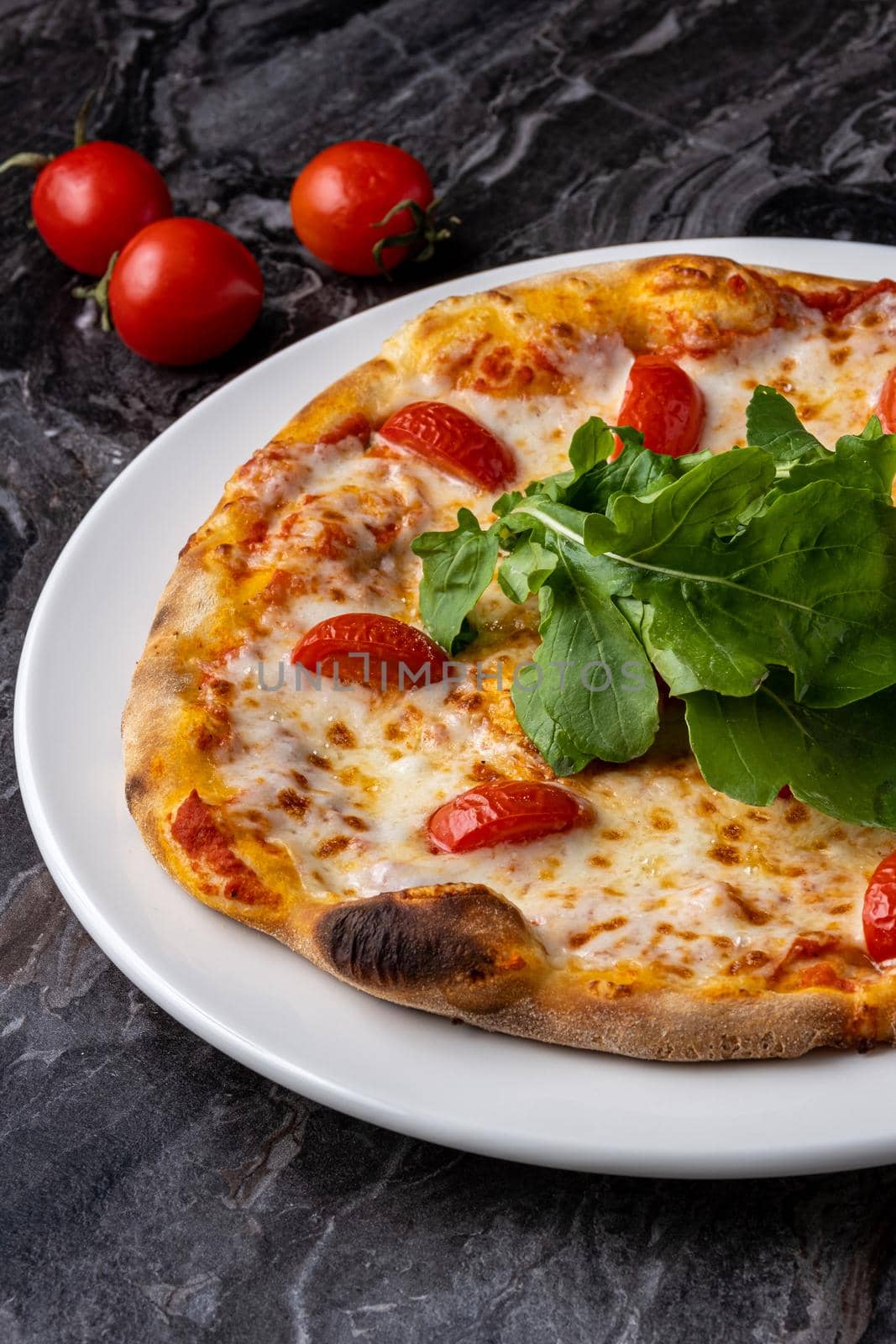 Delicious hot homemade pizza on the stone table background