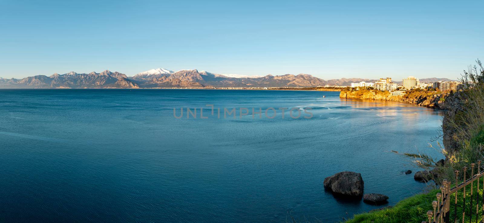 Panoramic view of Antalya on a sunny winter day with sea and snowy mountains