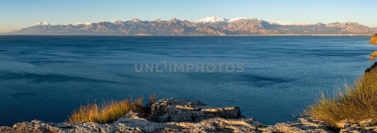 Panoramic view of Antalya on a sunny winter day with sea and snowy mountains