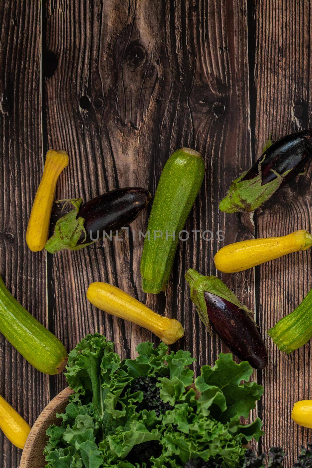 green leafy kale vegetable in bamboo bowl on wooden table background