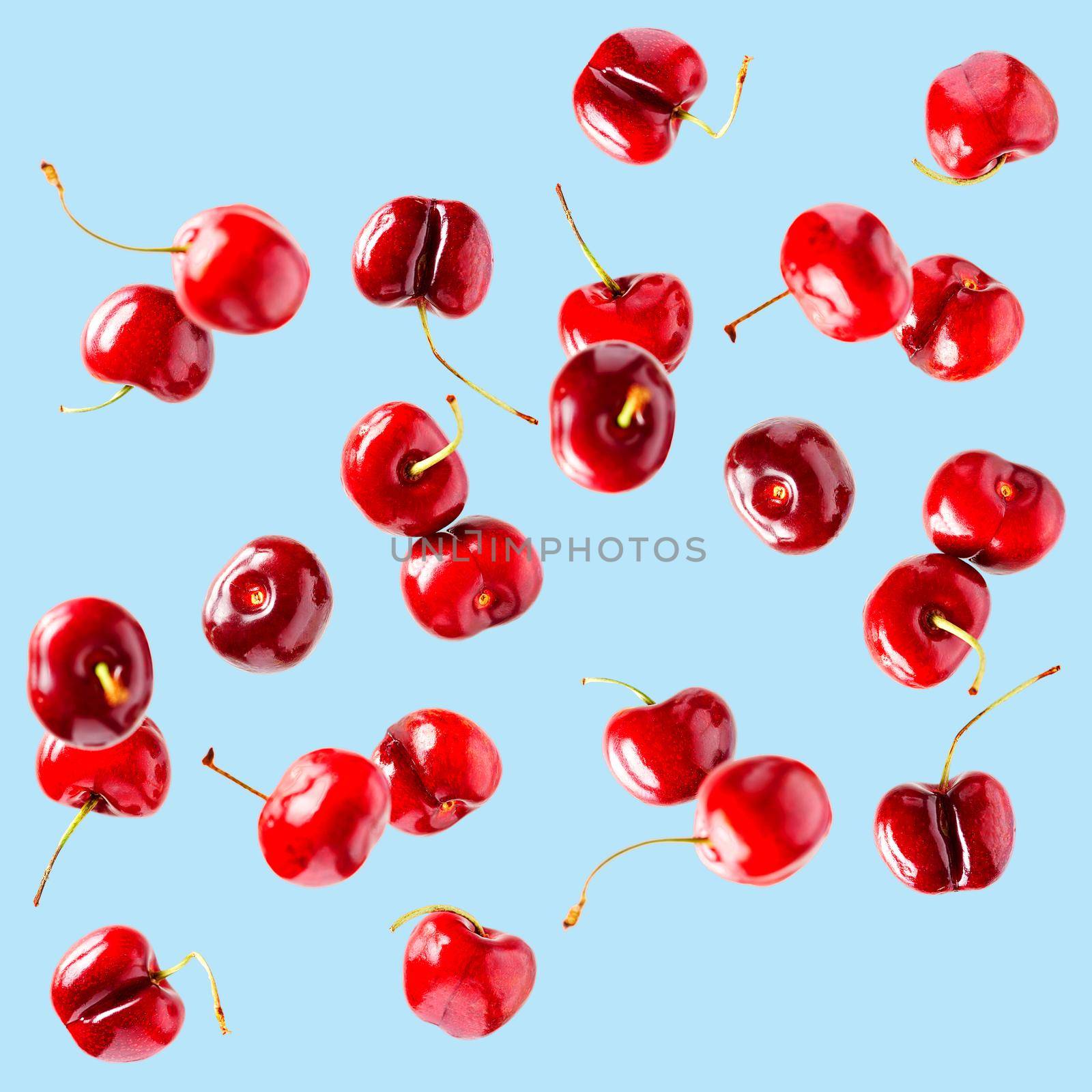 Flying cherries vertical isolated as package design elements. Fresh raw cheery falling in the air by PhotoTime