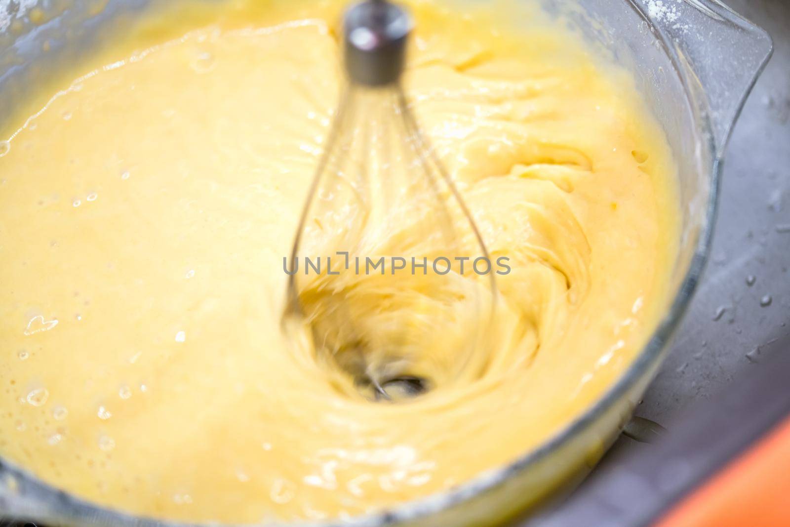 Motion blur photo of mixing homemade delicious cake
