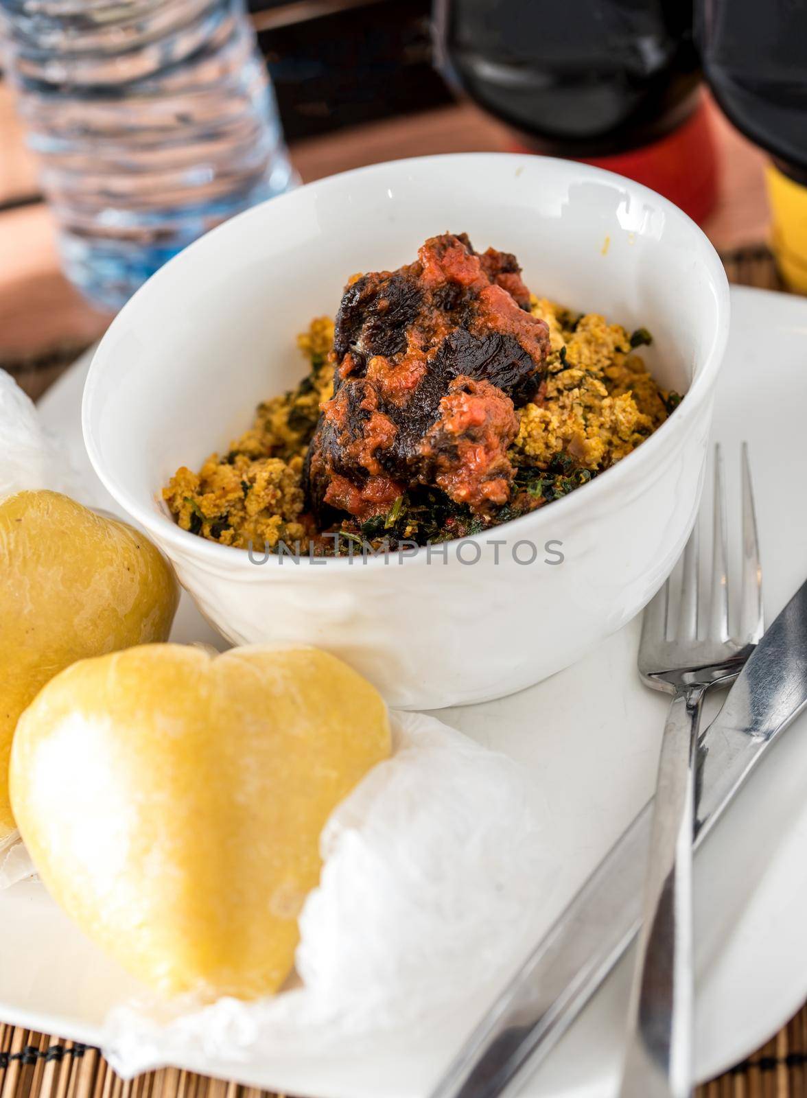 Regional African Food on white plate on wooden background