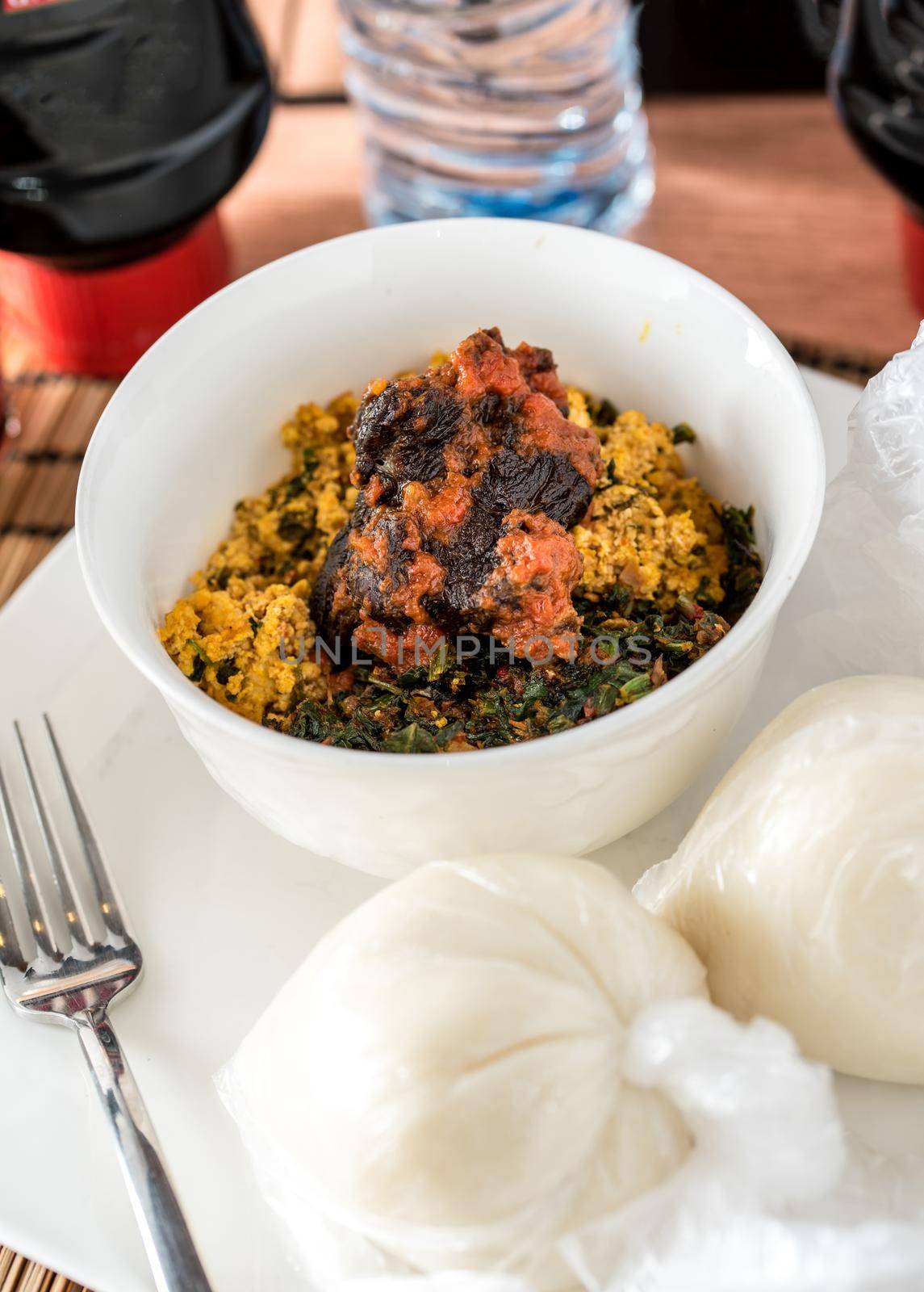 Regional African Food on white plate on wooden background