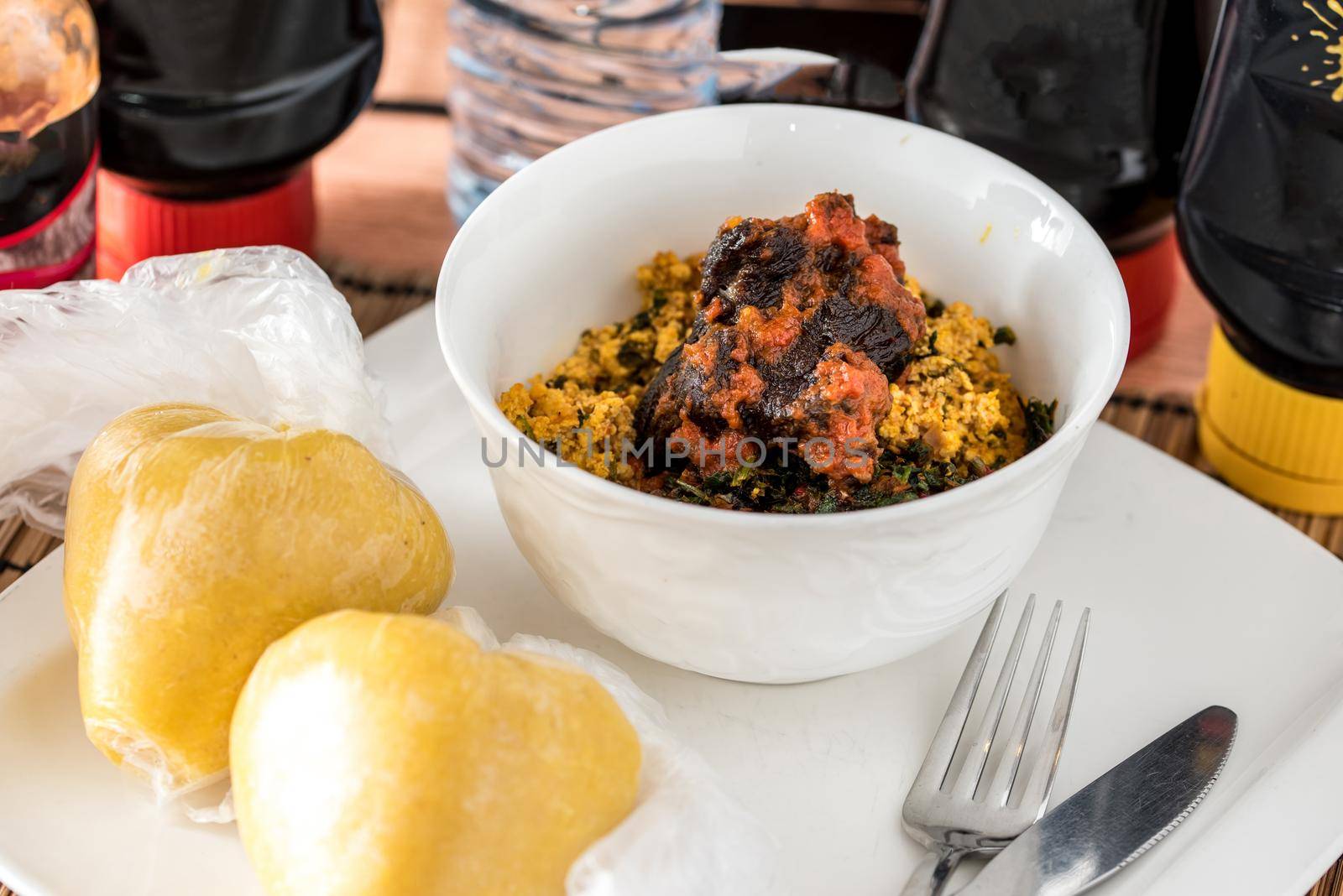 Regional African Food on white plate on wooden background