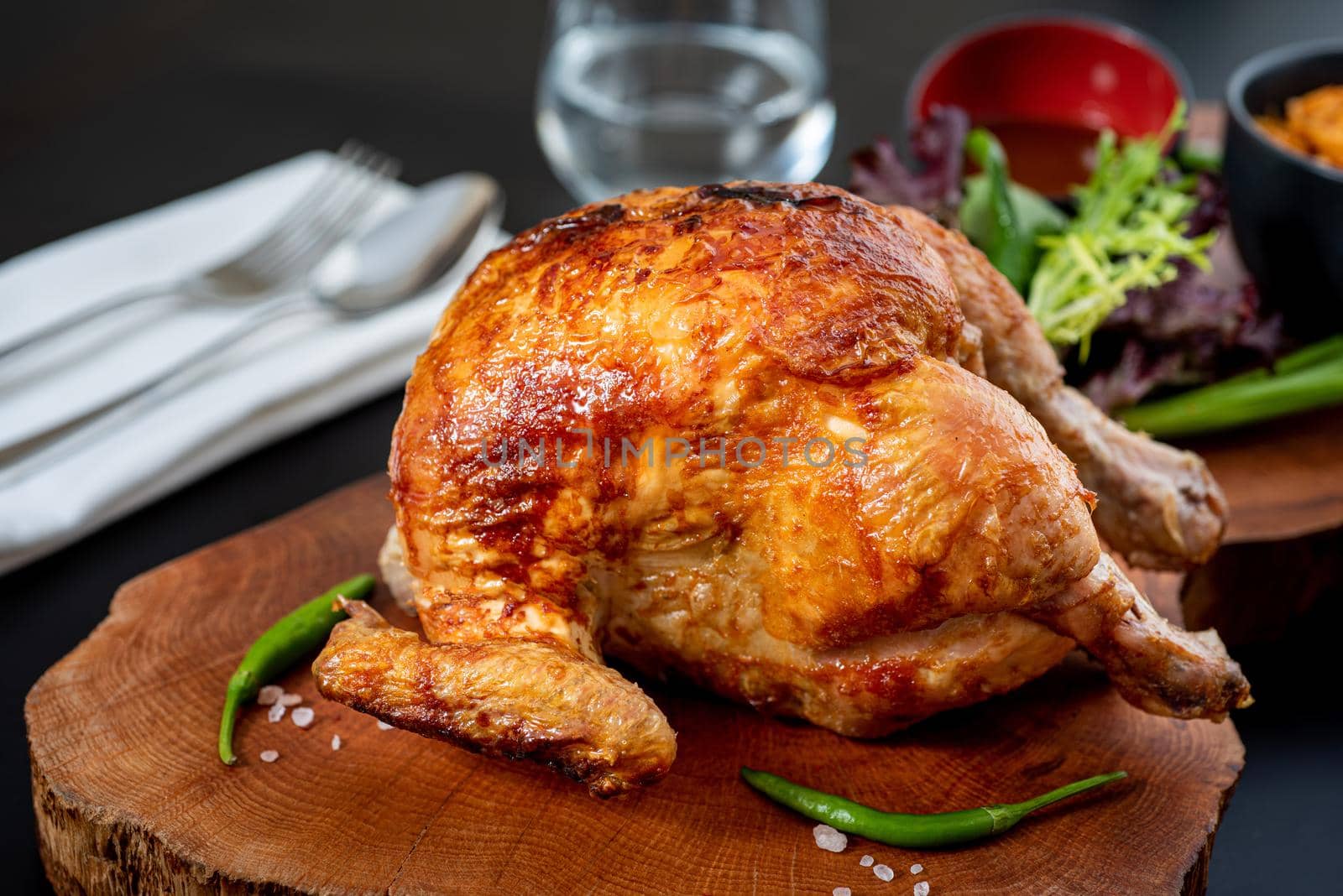 Roasted whole chicken cooked on charcoal with bulgur pilaf on wooden board. by Sonat