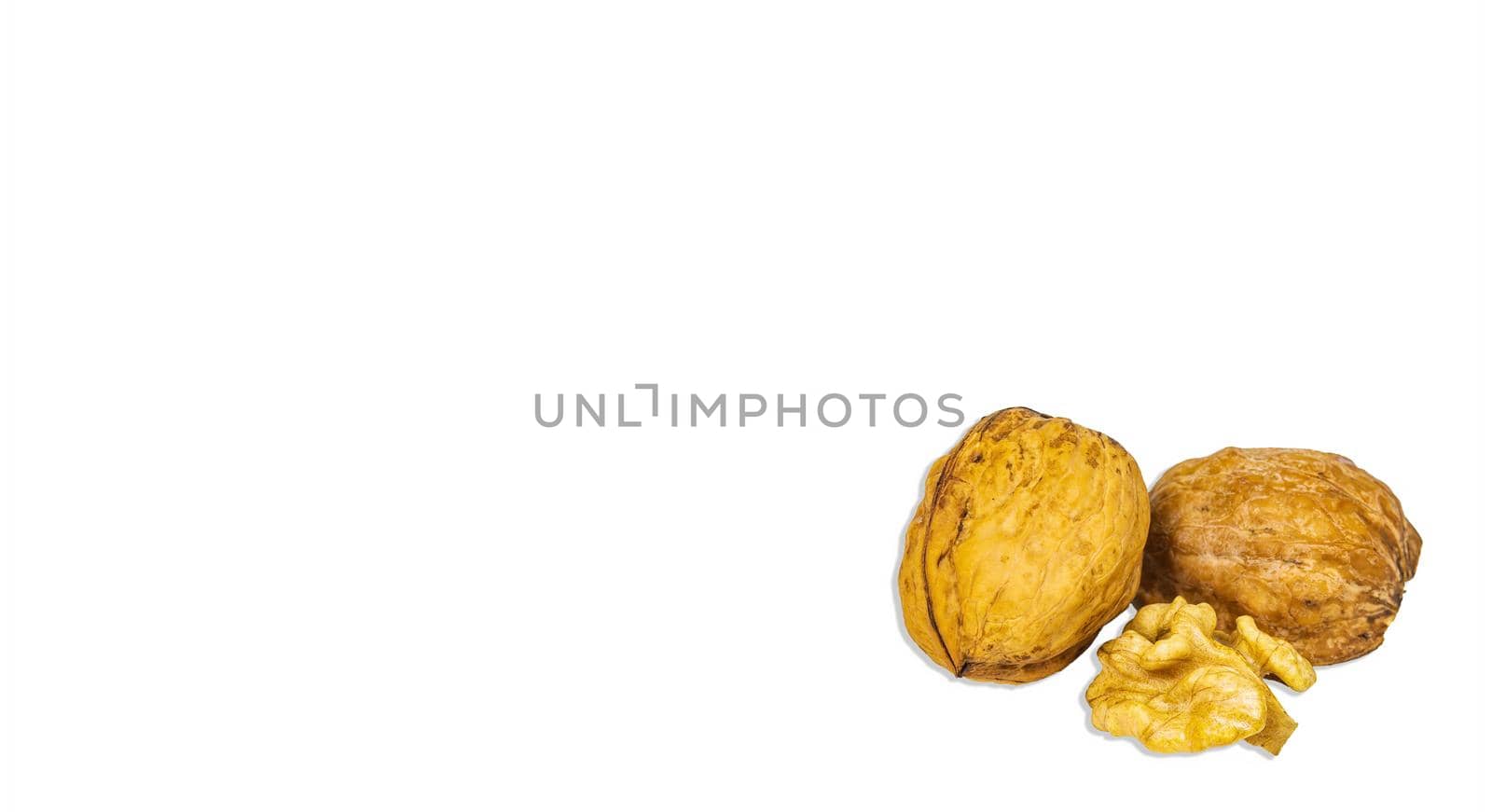 Two halves of a split walnut isolated on a white background. Juglans regia. Walnut shell. Healthy food. Iodine in nuts. Nut core. Vegetarian food. Culinary ingredient. White background.