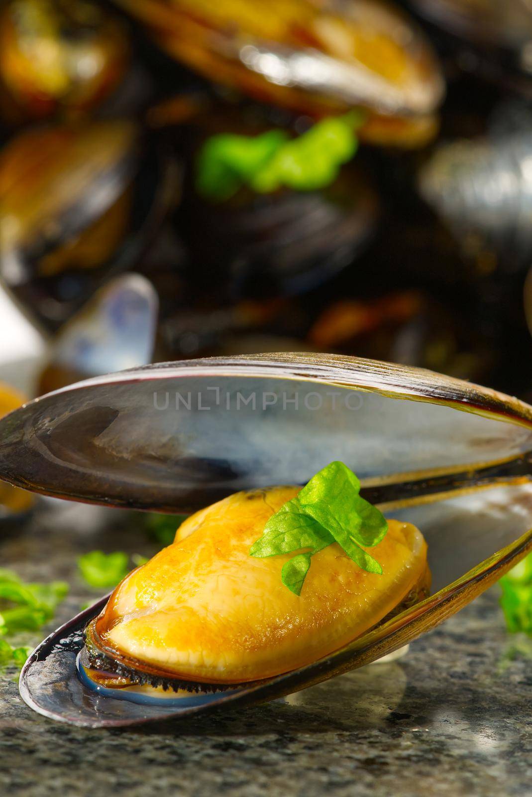 Cooked mussels with lemon and parsley on table. served mussels ready to eat by PhotoTime