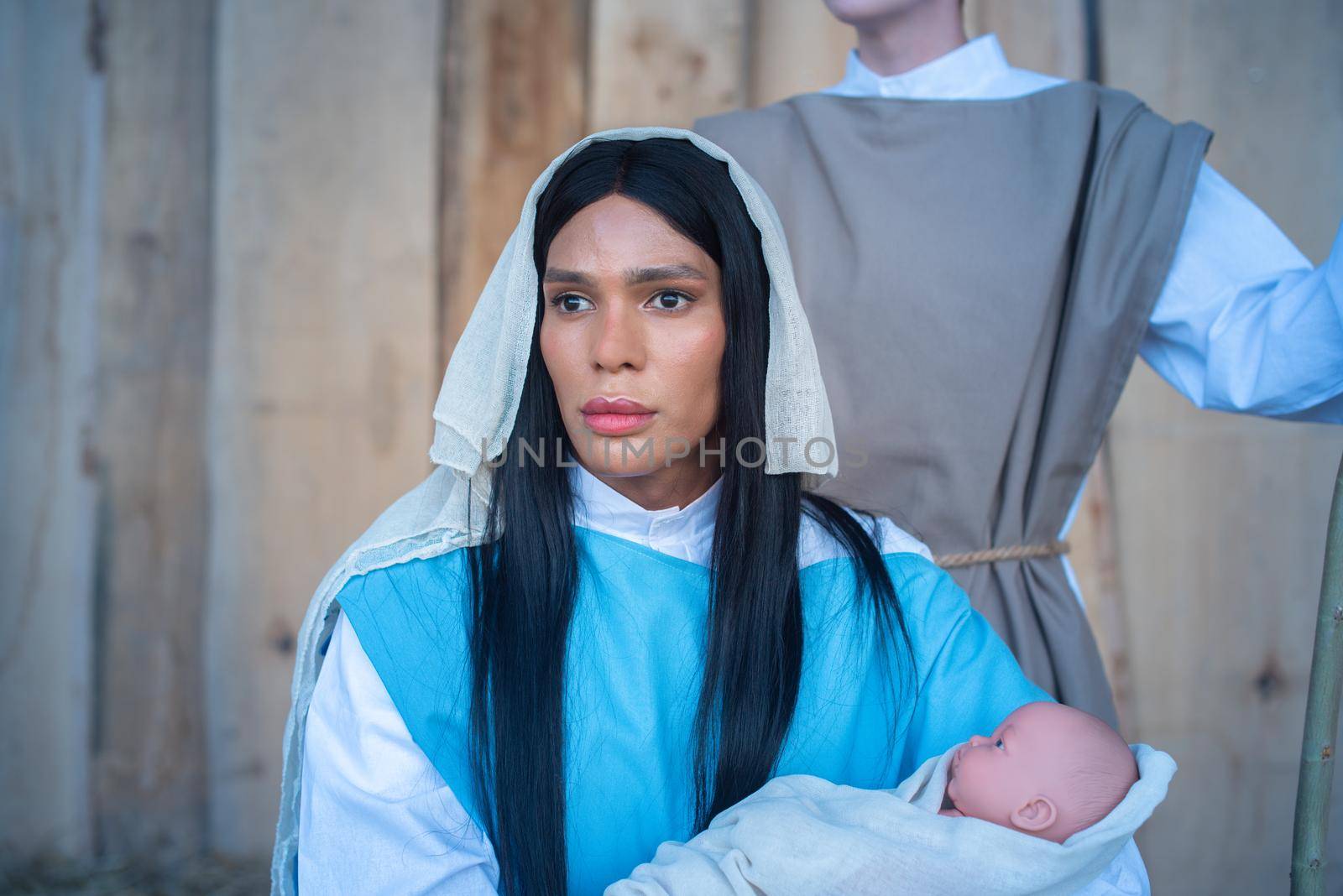 Portrait of a transgender person representing the virgin mary in a Bethlehem at christmas time