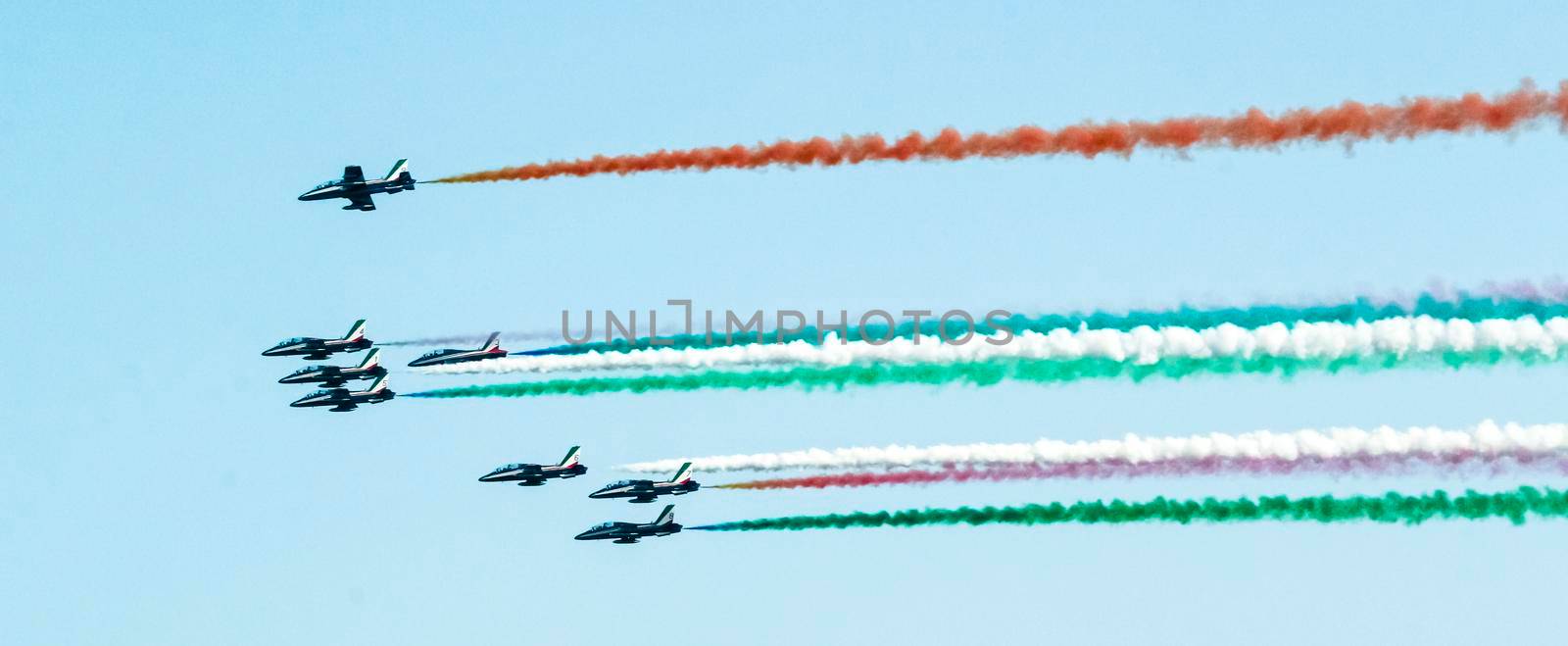 tricolor braids of the Italian military aviation, flight during an exhibition, the smoke of the planes forms the colors of the Italian flag