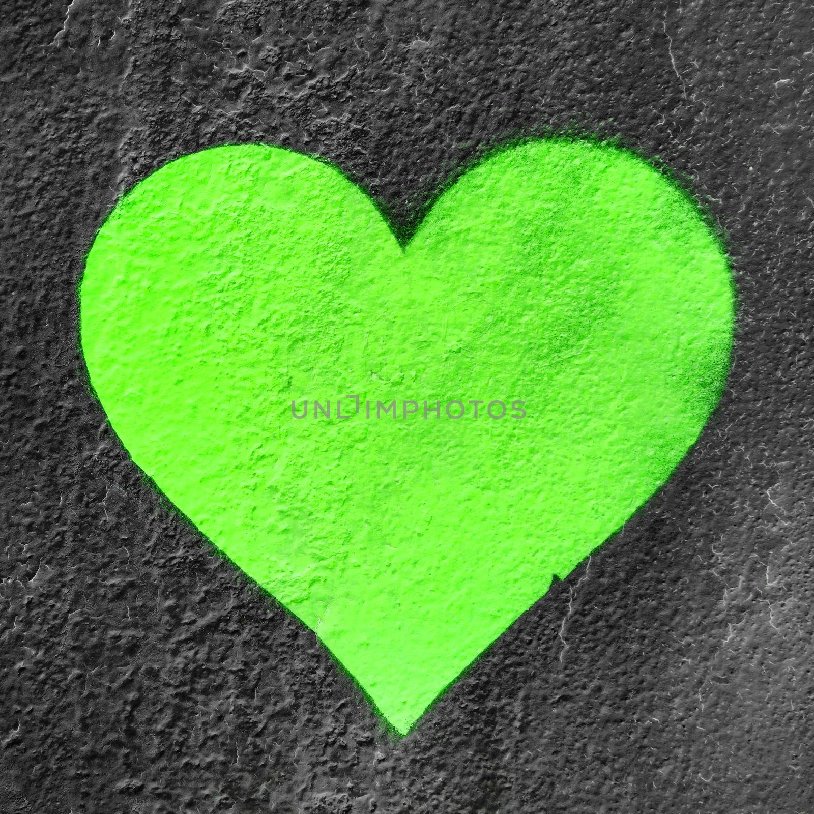 Green urban heart. Fluo love heart hand drawn on grungy wall. Textured background trendy street style.