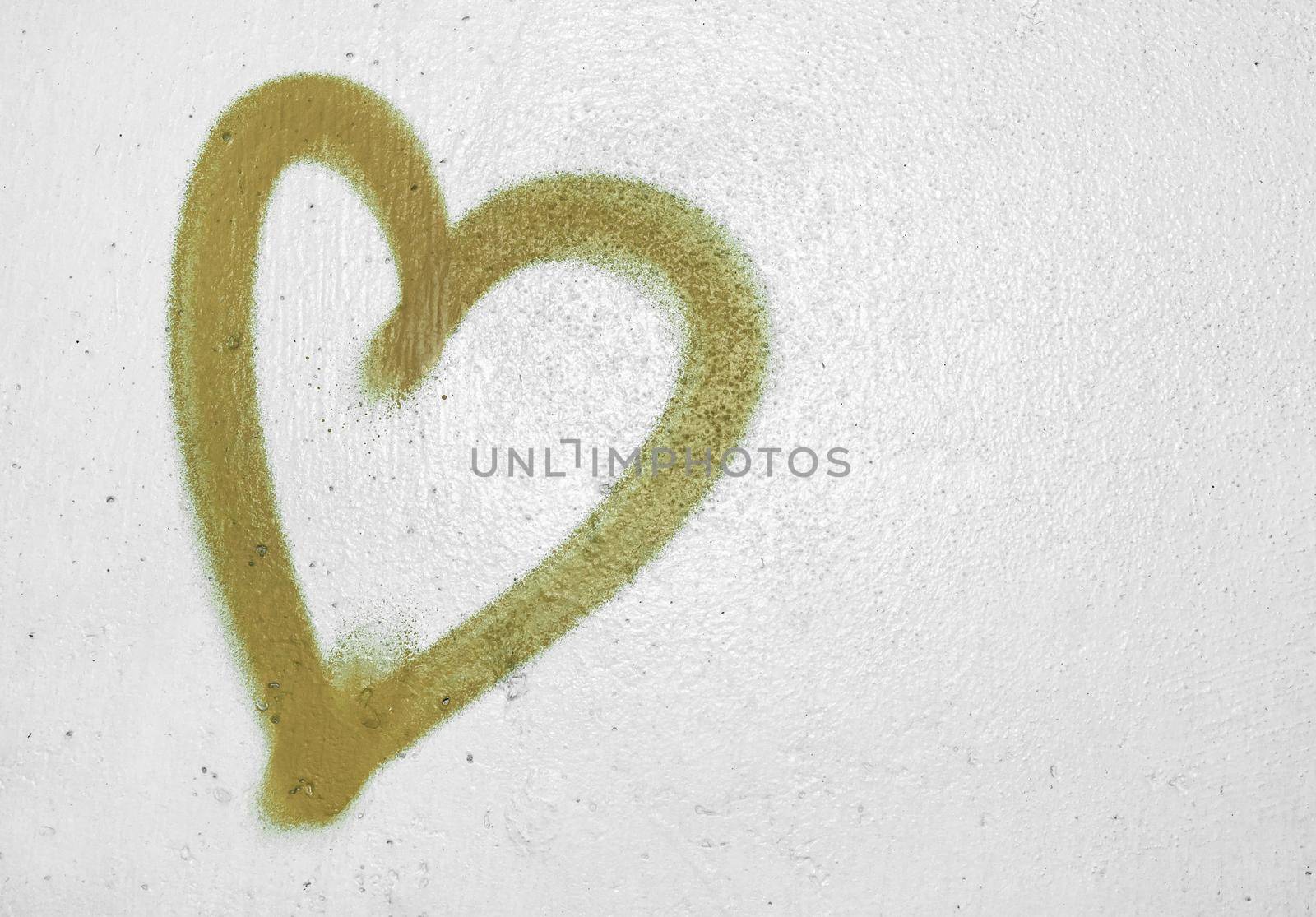 Concept or conceptual painted golden abstract heart shape love symbol, dirty wall background, metaphor to urban and romantic valentine, grungy style.