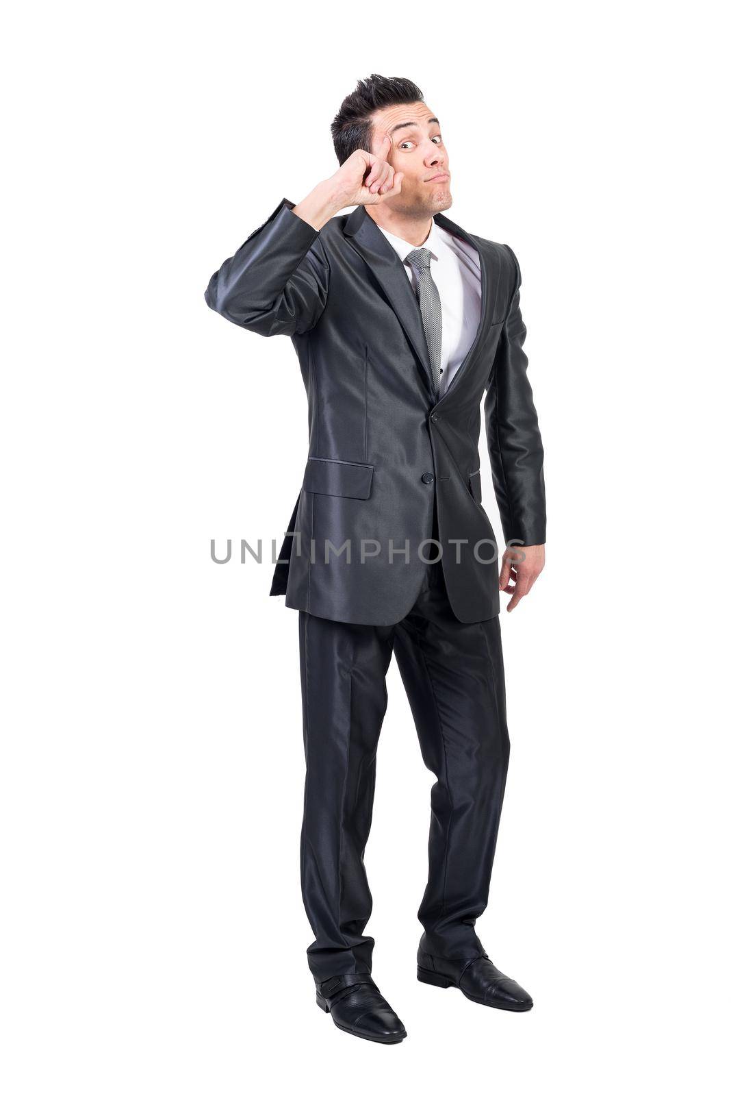 Full body of funny clever male entrepreneur in formal suit touching head and looking at camera against white background