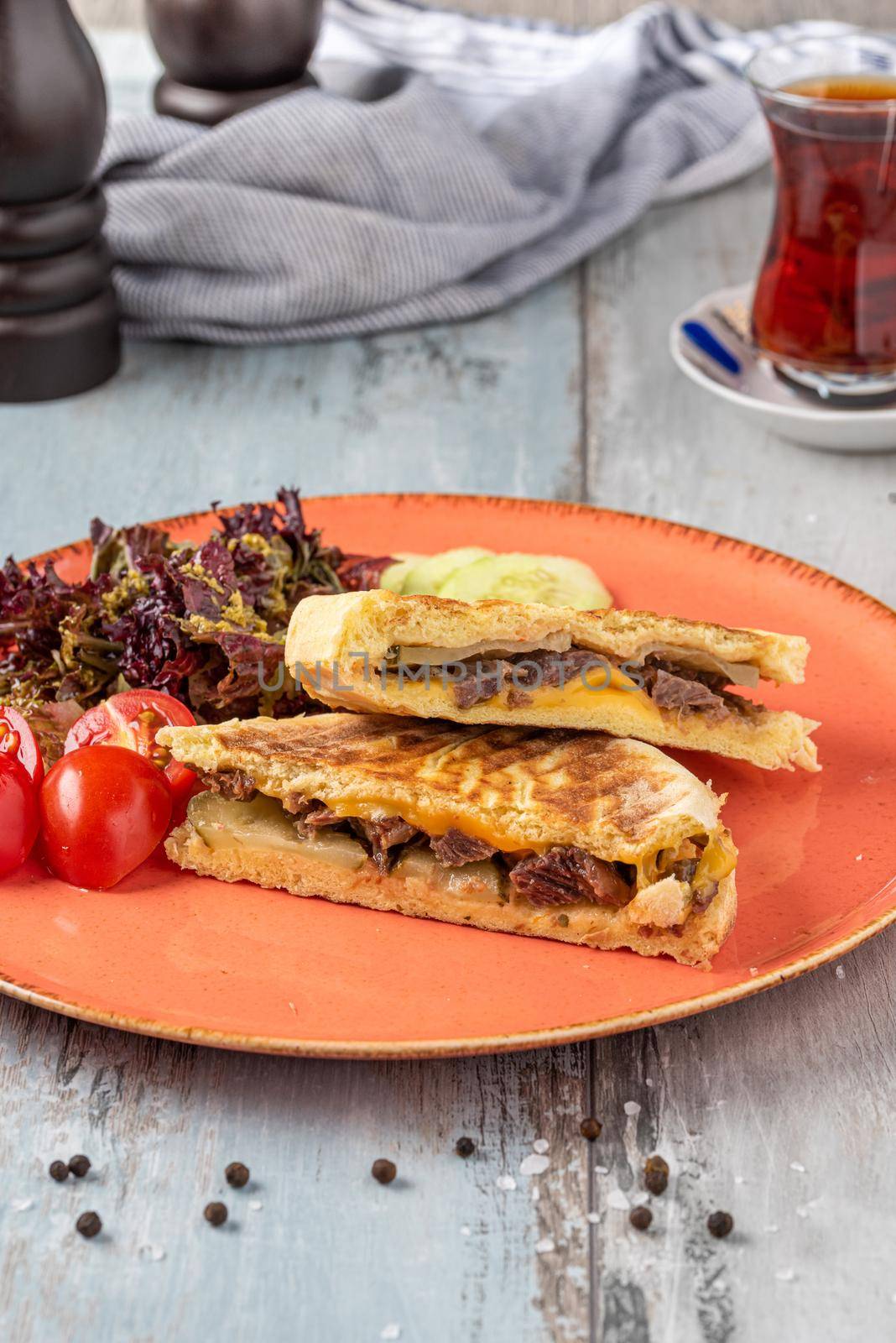 Turkish toast with roasted meat served with turkish black tea