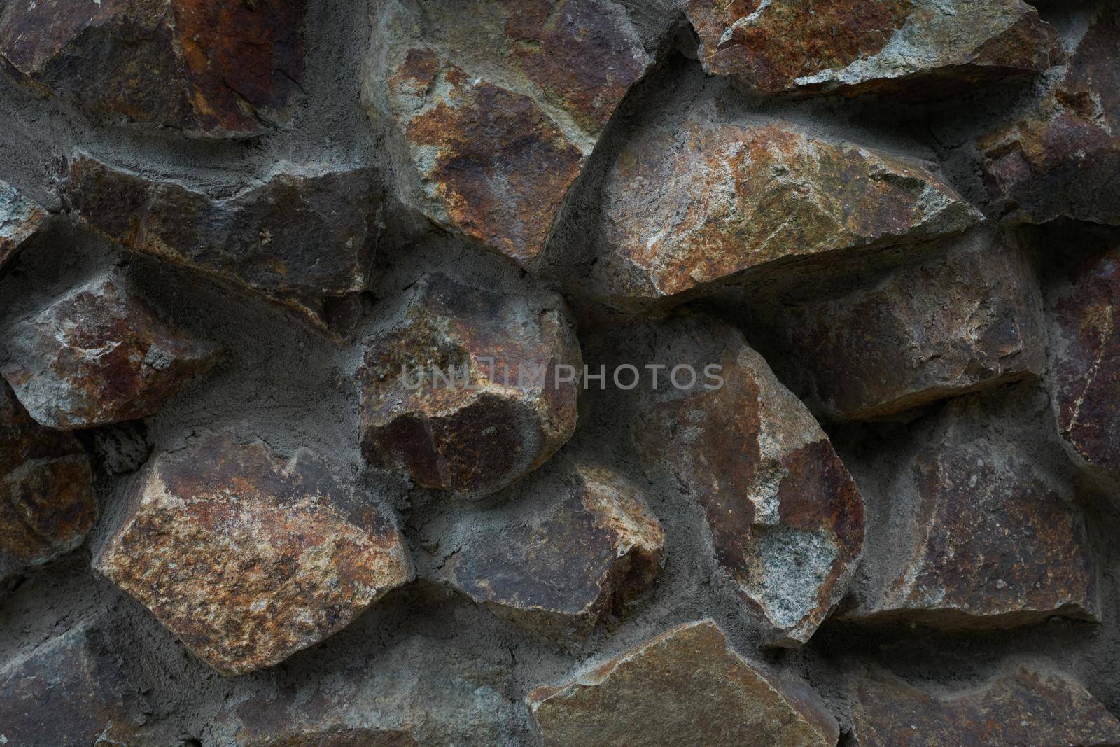Close-up view of rough stone wall textured background