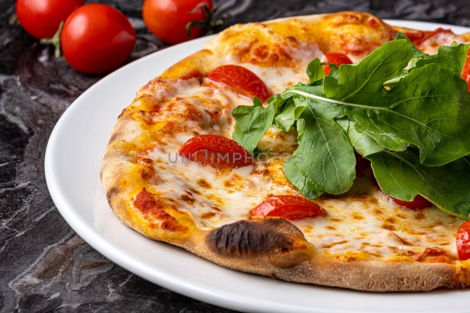 Delicious hot homemade pizza on the stone table background