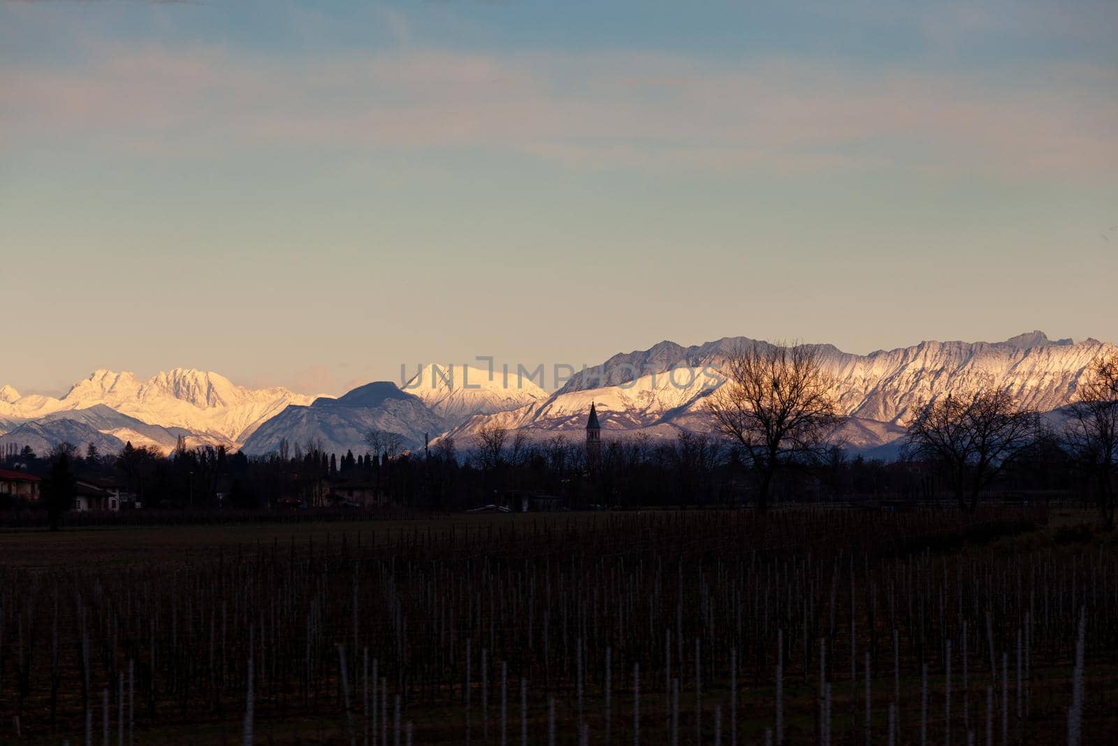View of the Italian countryside with alp mountains on the background by bepsimage