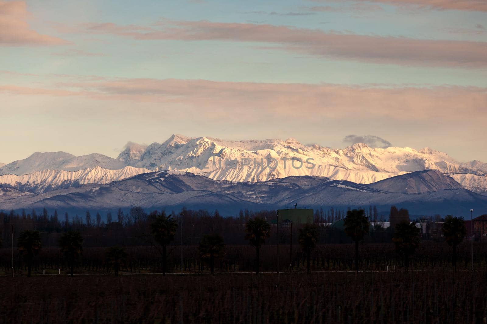 View of the Italian countryside with alp mountains on the background in the winter season