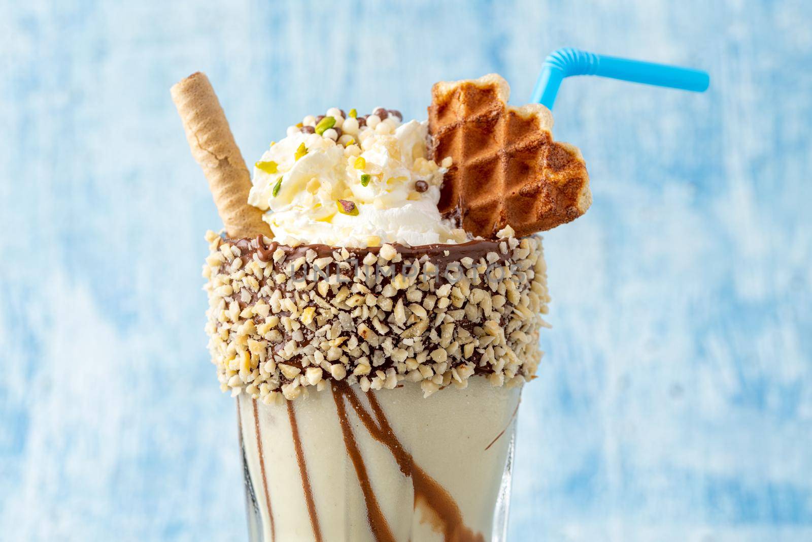 Chocolate milkshake with banana on blue background