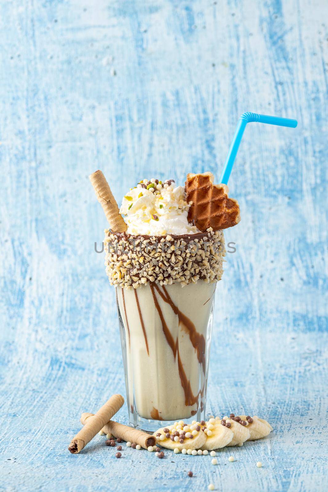 Chocolate milkshake with banana on blue background