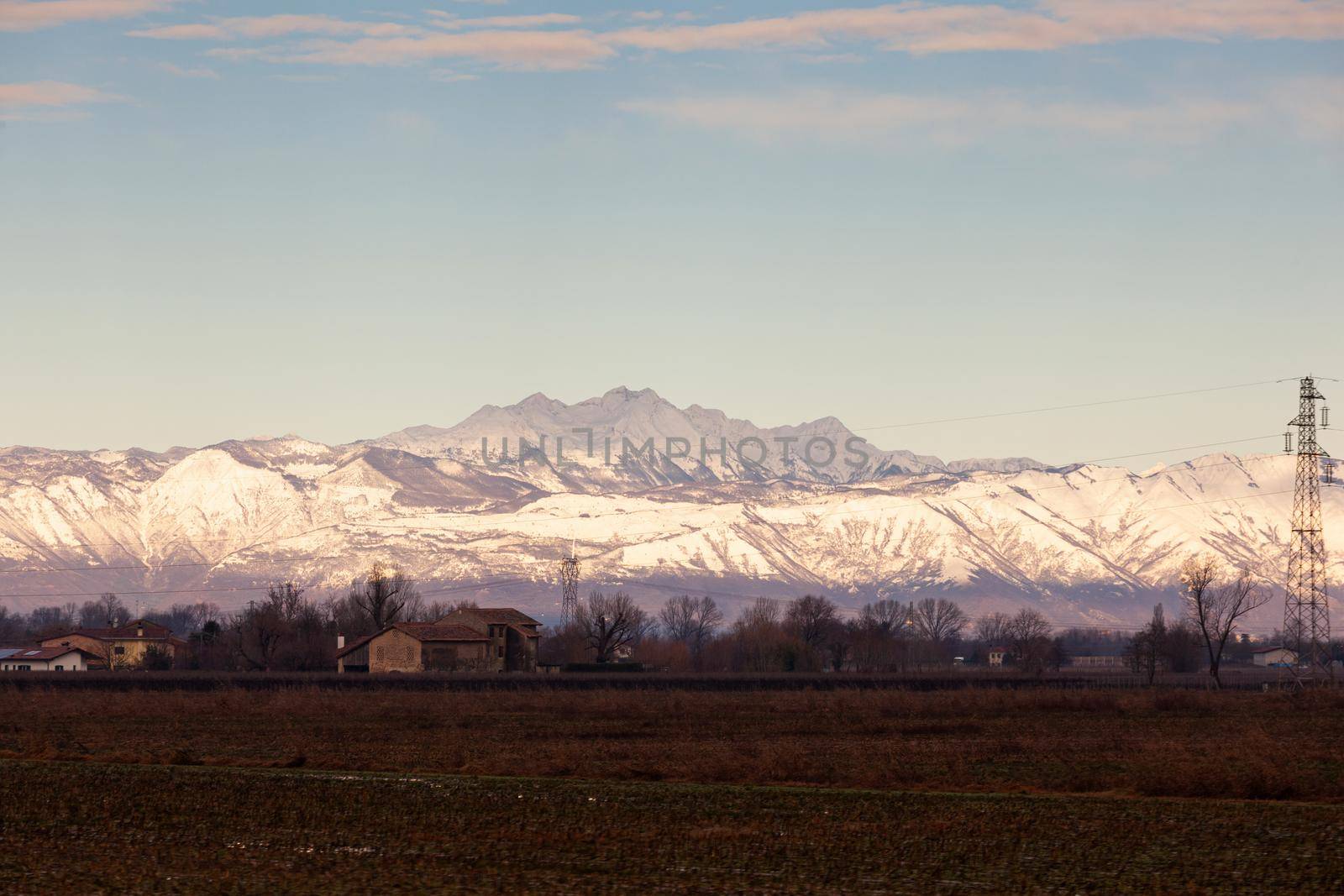 View of the Italian countryside with alp mountains on the background by bepsimage