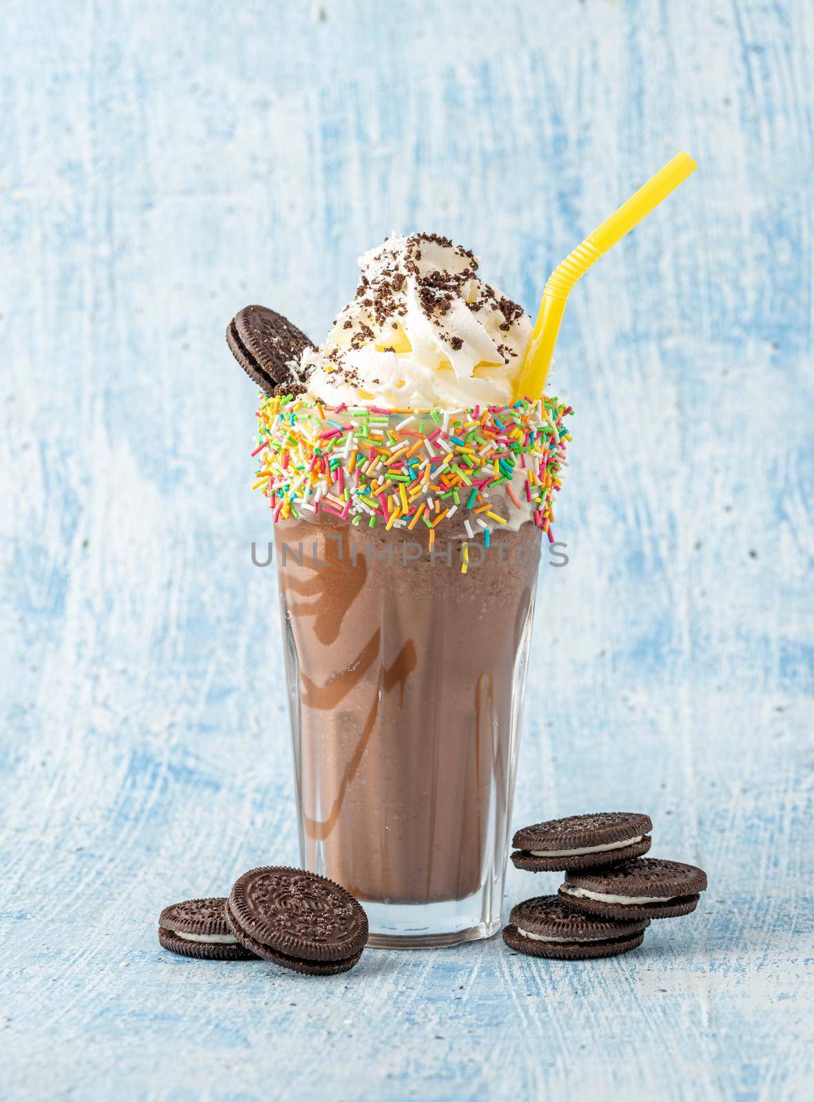 Cream and chocolate milkshake on blue background