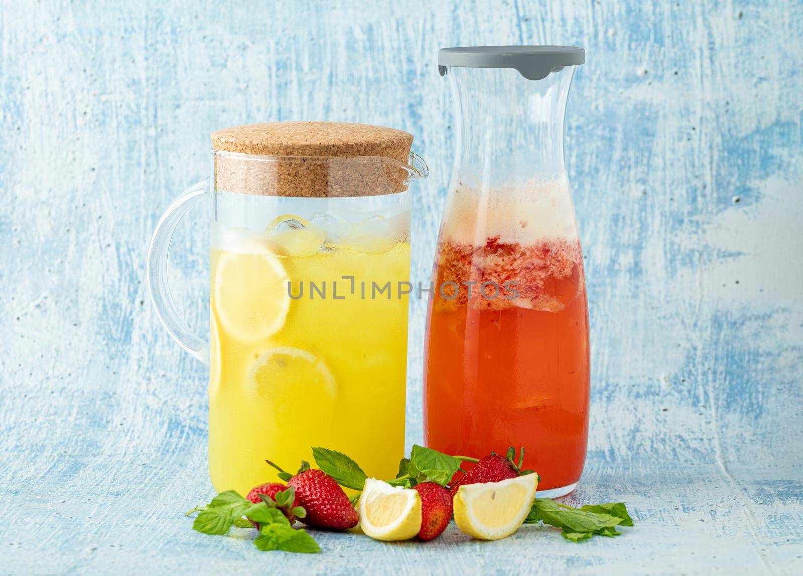 refreshing lemonade with lemon, strawberry and mint on blue background by Sonat