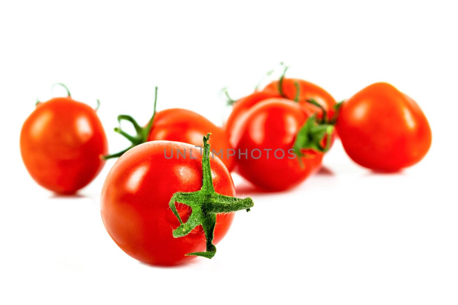 Fresh cherry tomatoes on a white background