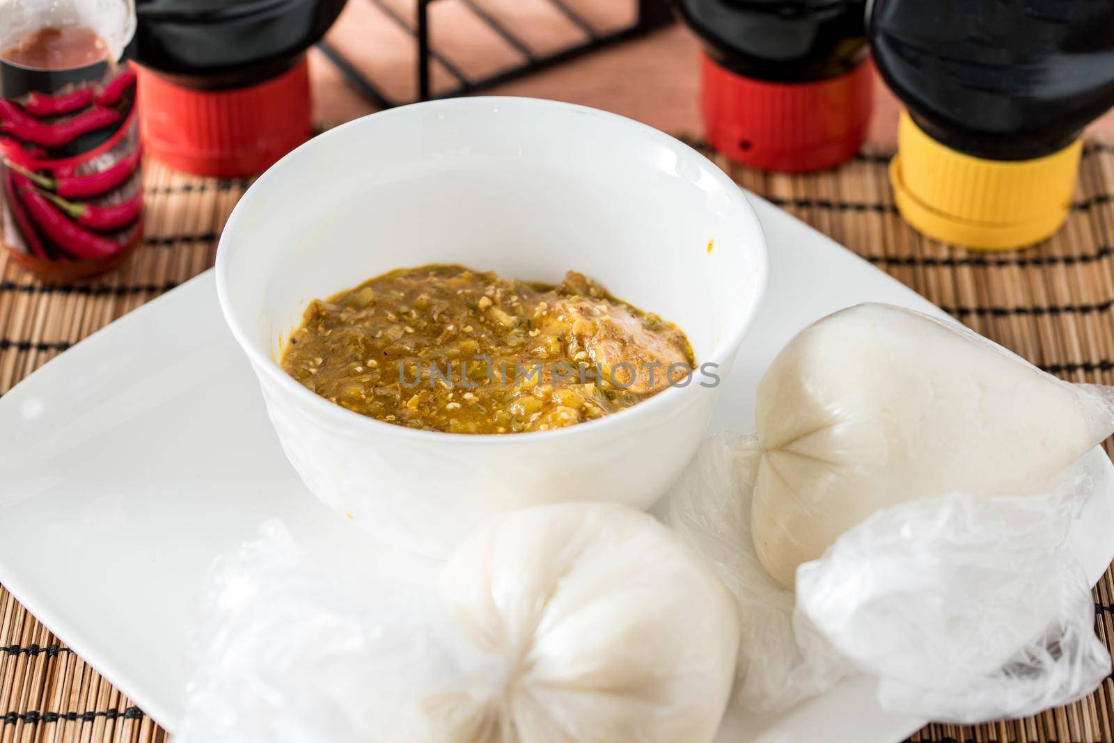 Regional African Food on white plate on wooden background