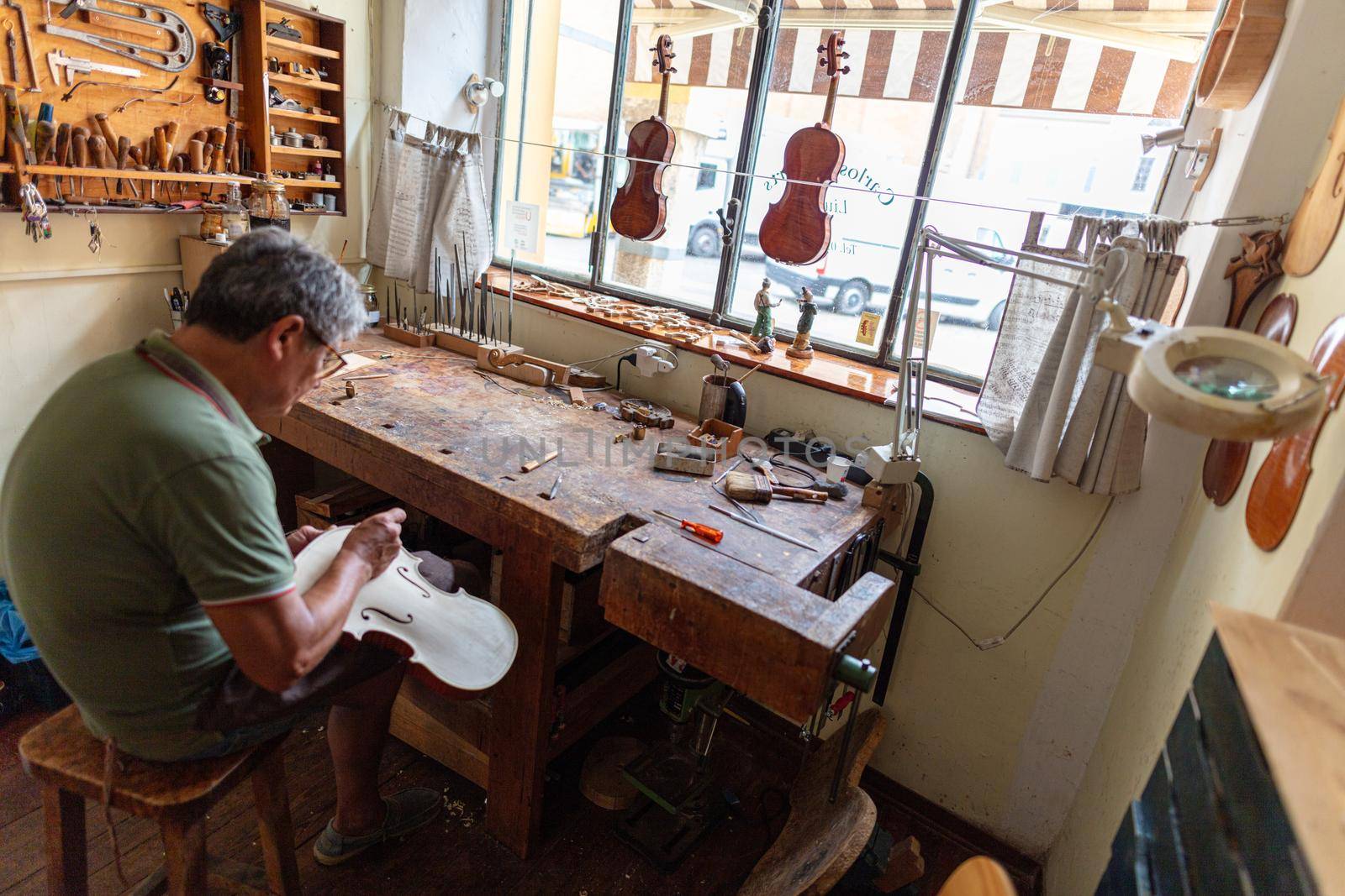 violinmaker at work in his italian workshop