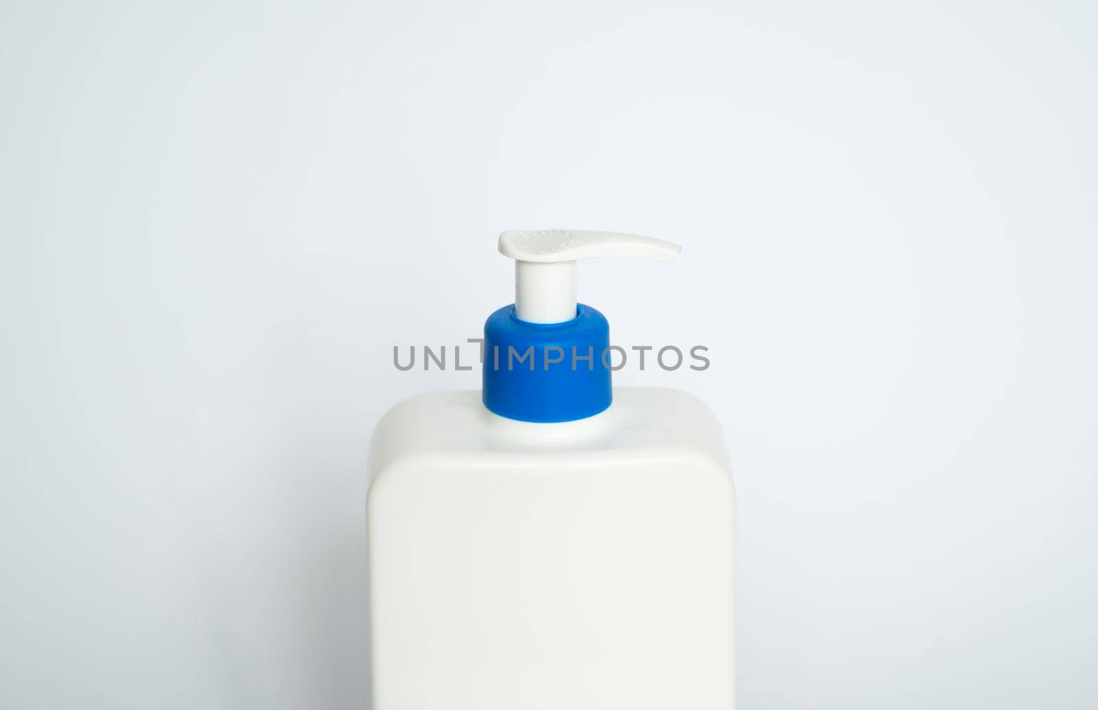 White unbranded plastic dispenser pump bottle on white background. Cosmetic package mockup, liquid soap flacon, hand sanitizer without label, shampoo organic spa, shower gel. by vovsht