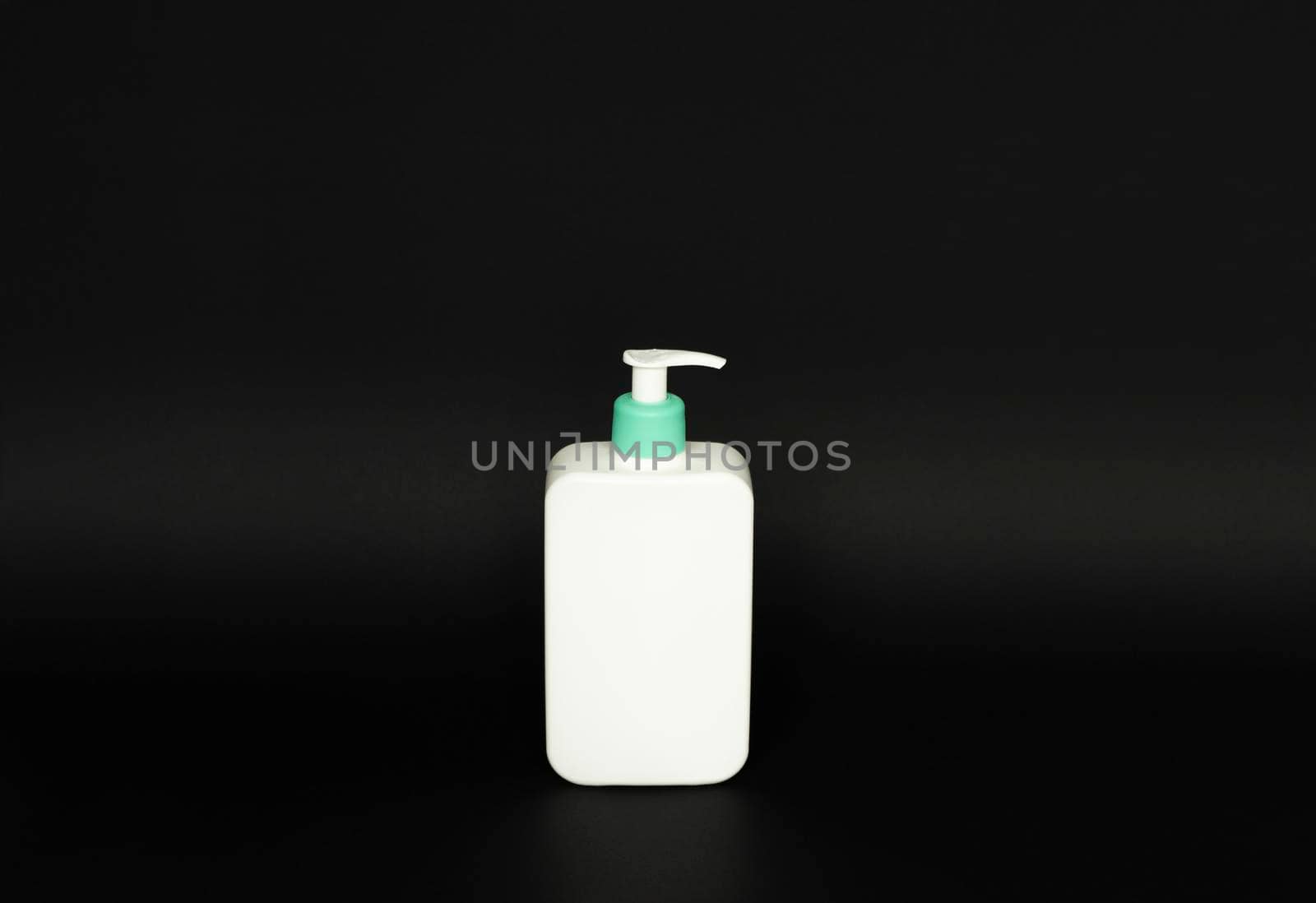 White unbranded plastic dispenser pump bottle on black background. Cosmetic package mockup, liquid soap flacon, hand sanitizer without label, shampoo organic spa, shower gel. by vovsht