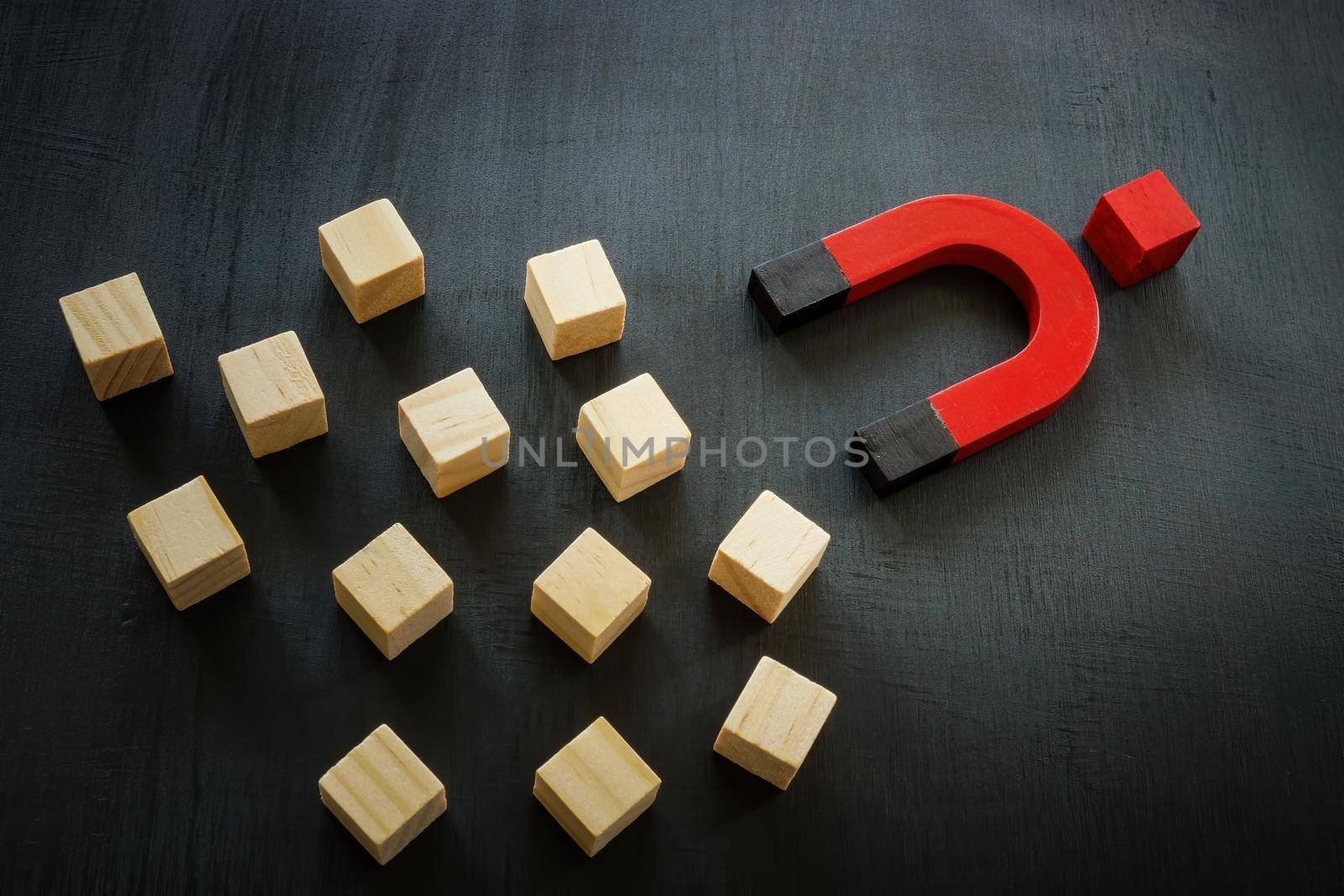 Cubes, magnet and one red cube. Charismatic leadership.