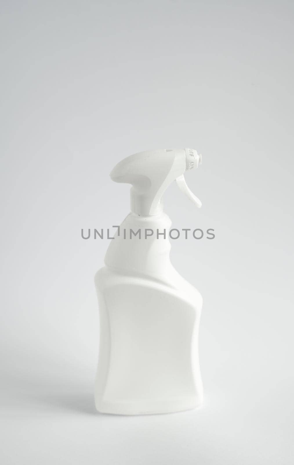 White detergent bottles or chemical cleaning supplies with a sprayer isolated on white background