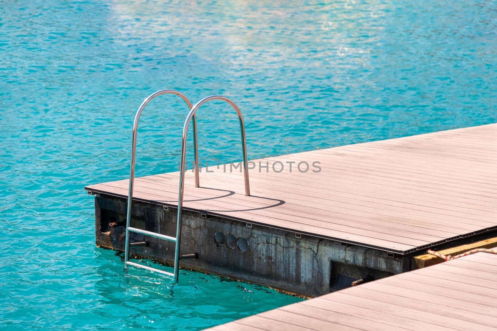 floating dock with composite deck and ladder at the marina.