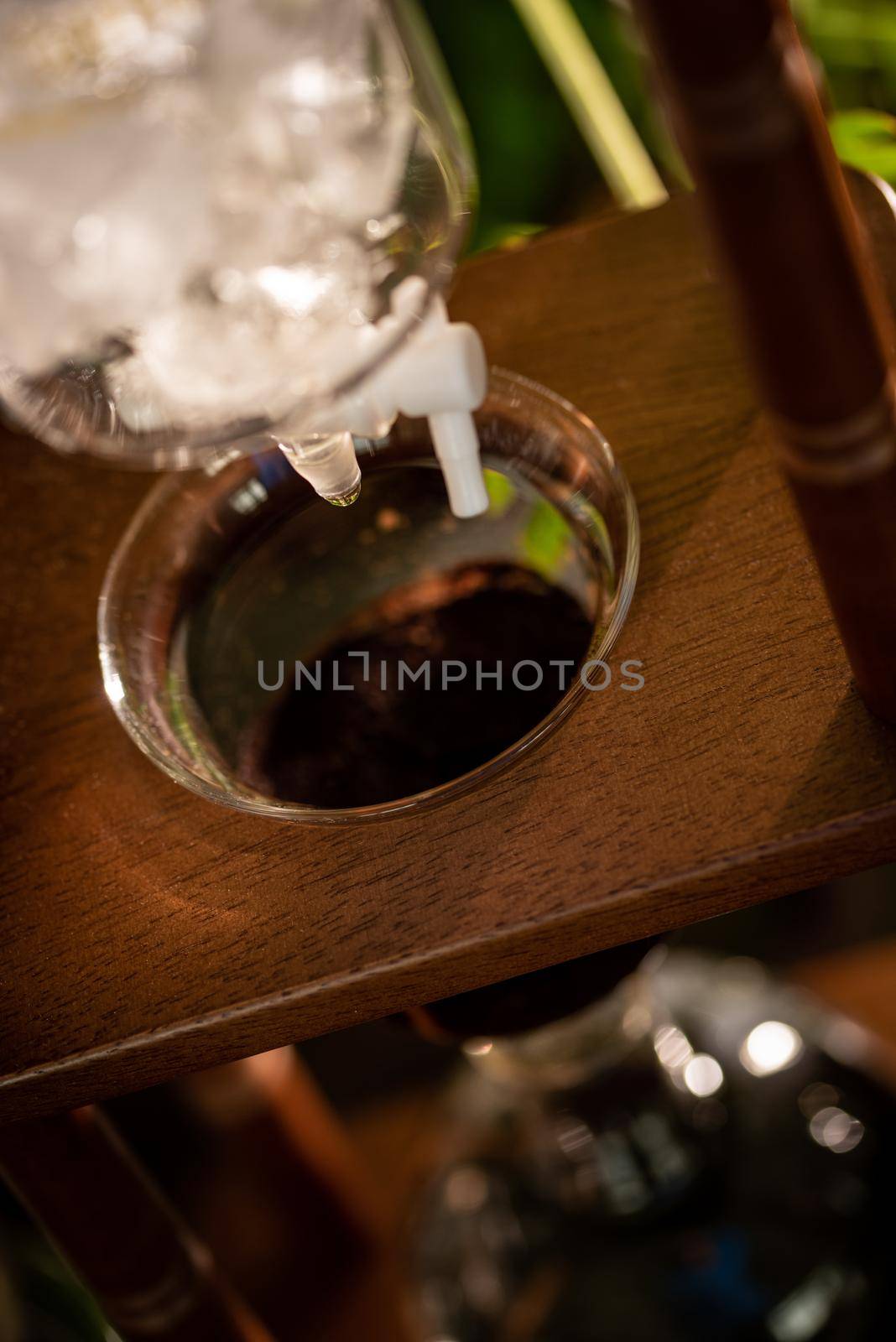 cold drip coffee tower with soft-focus and over light in the background