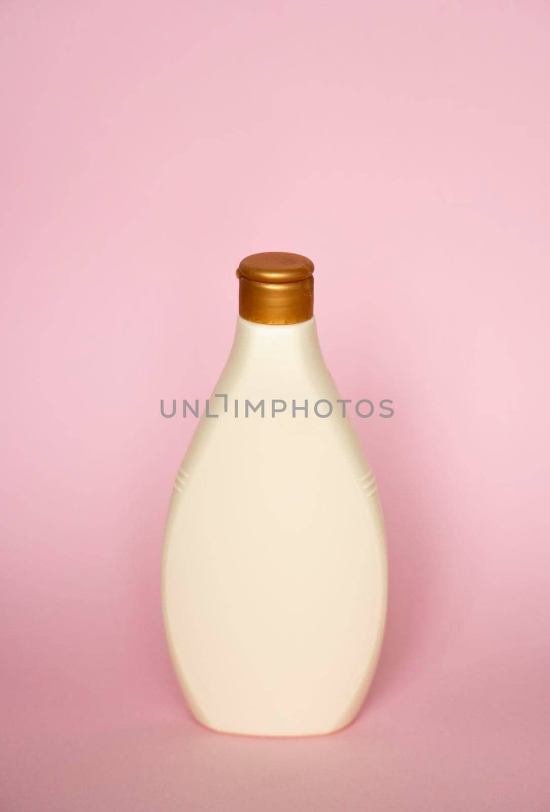 Beige blank plastic bottles isolated on pink background