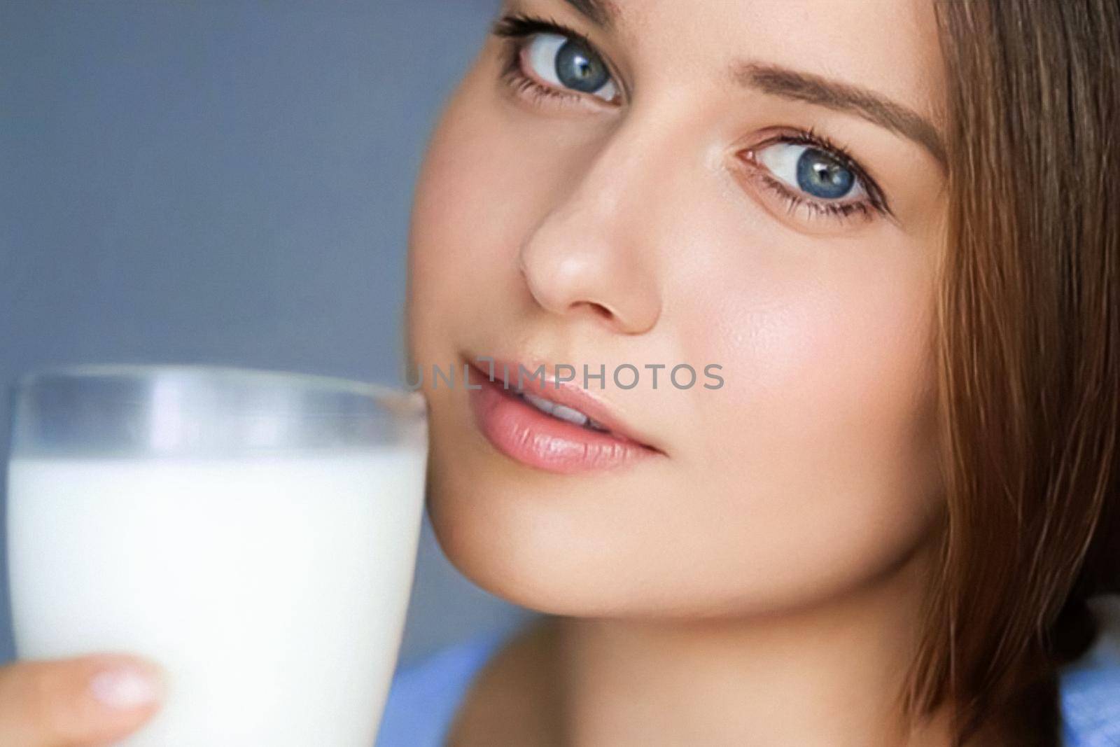 Happy young woman with glass of milk or protein milk shake, healthy cocktail drink for diet and wellness concept