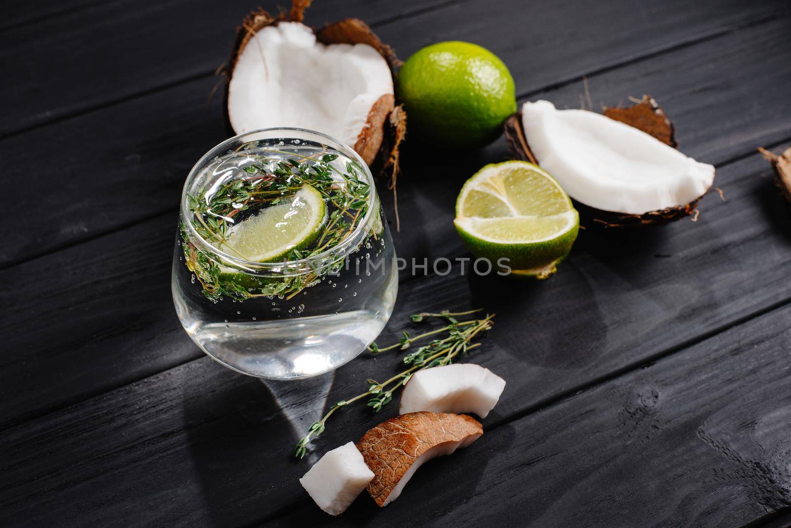 Coconut cocktail on a dark wooden background. coconut water with lime.