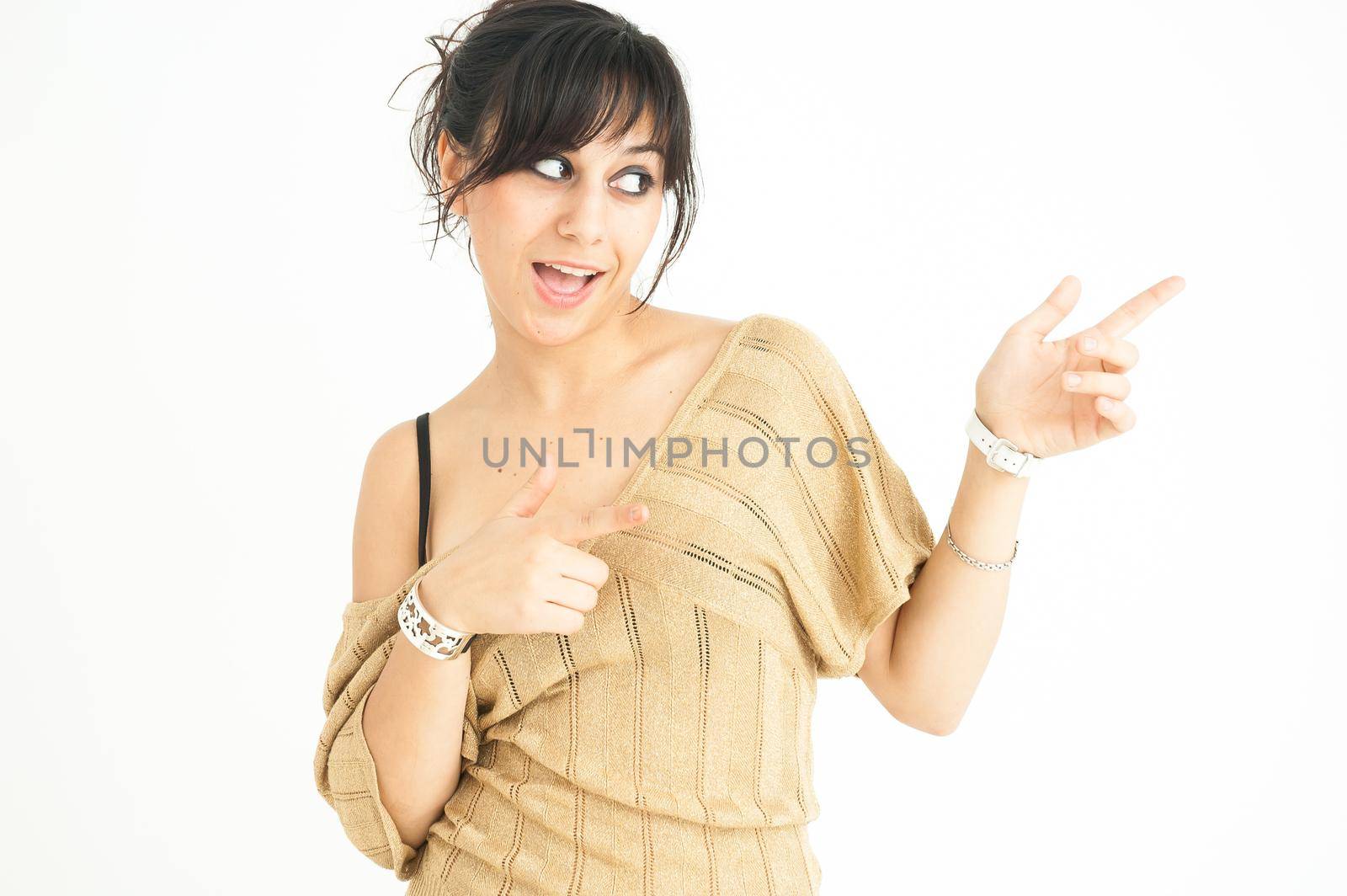 pretty girl smiling and pointing to the side with collected hair, on white background, medium shot
