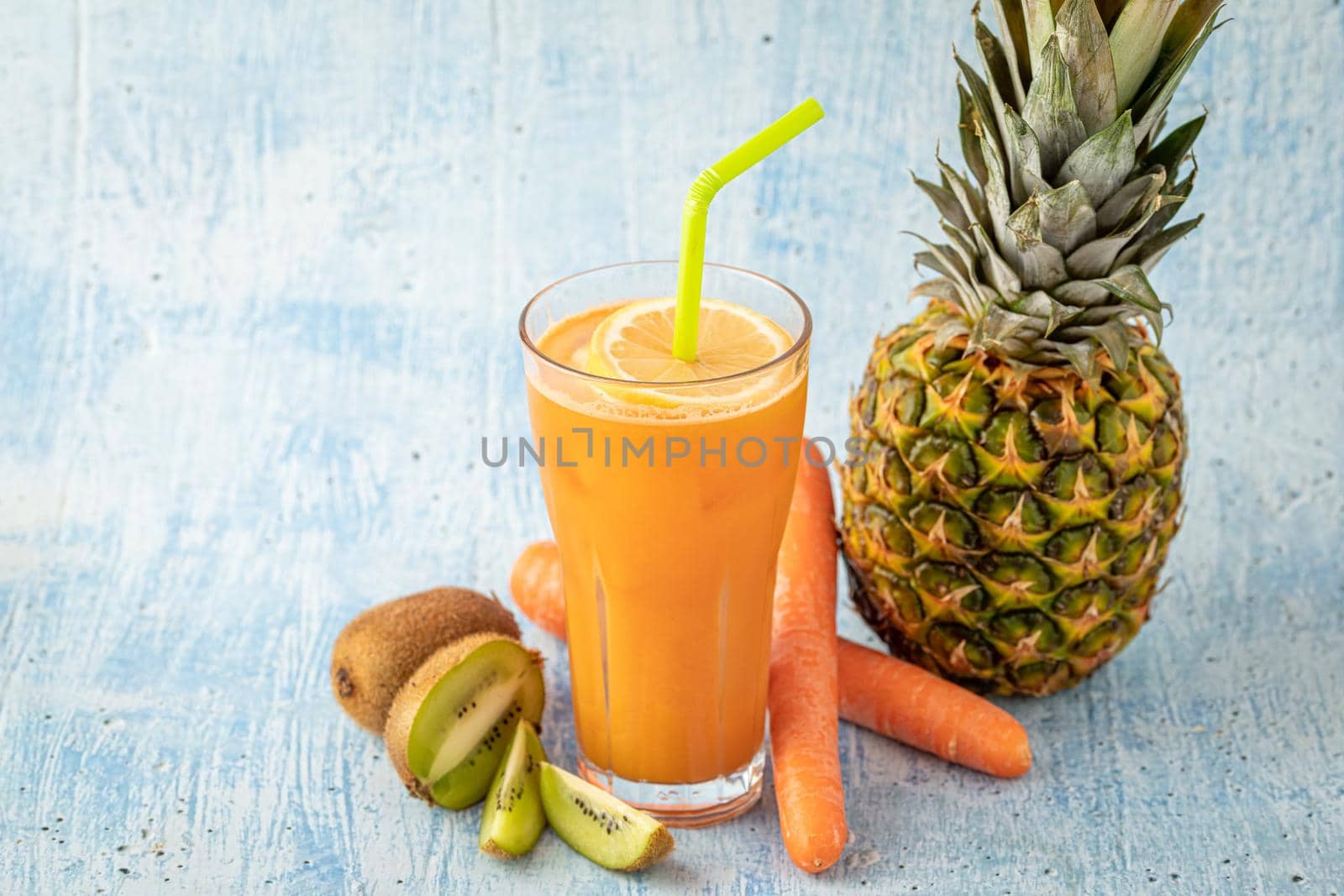 Refreshing and energizing orange juice with kiwi, pineapple and carrots