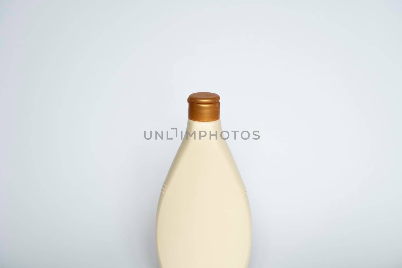Beige blank plastic bottles isolated on white background