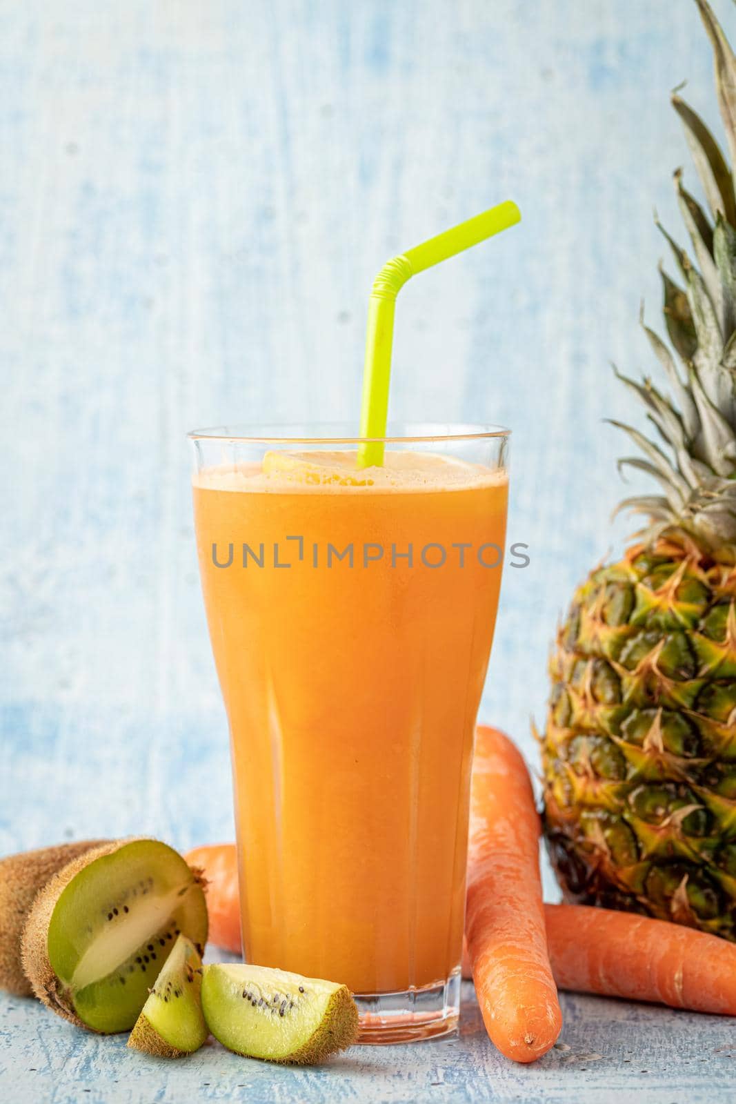 Refreshing and energizing orange juice with kiwi, pineapple and carrots by Sonat